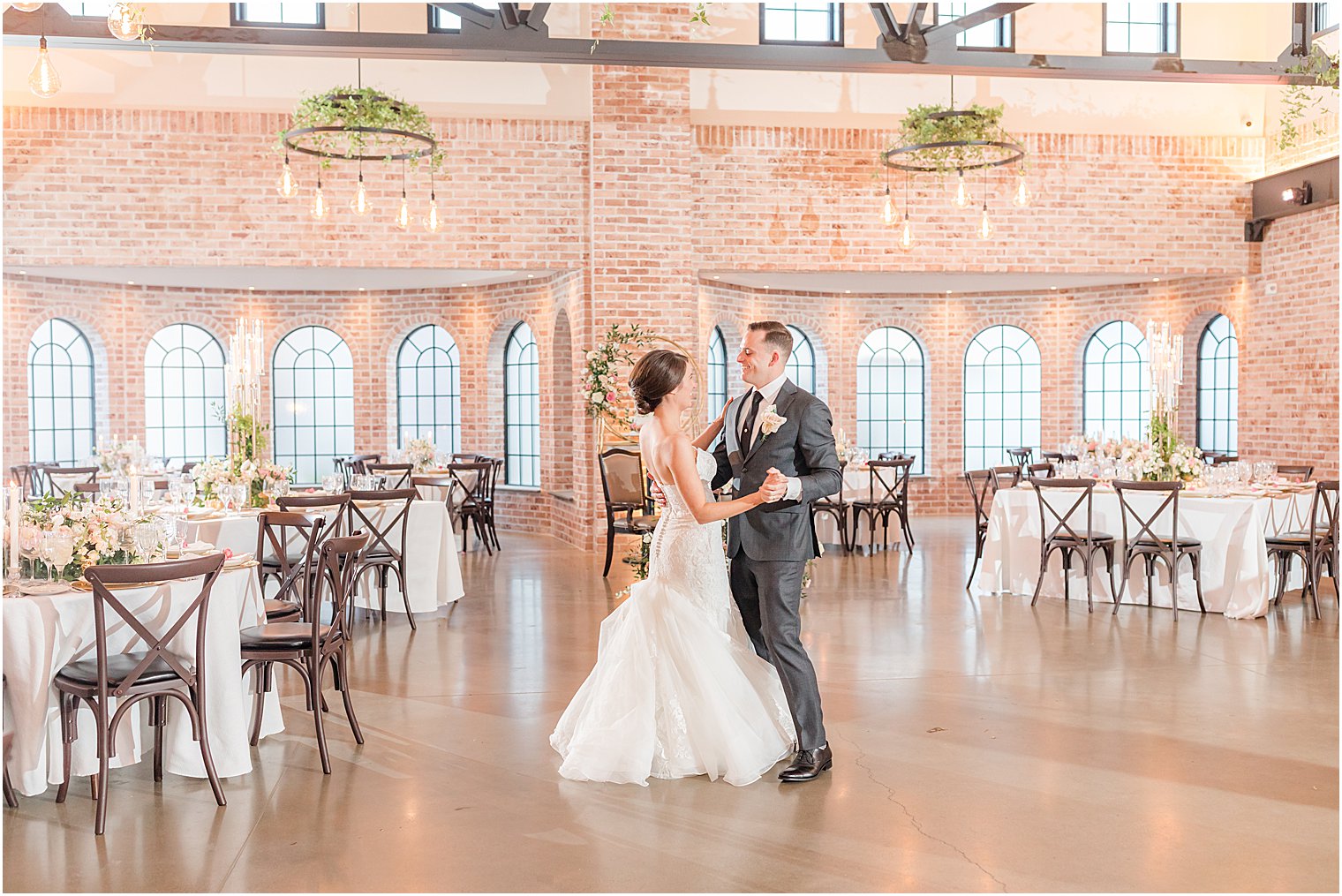 couple dances together in empty reception space at The Refinery at Perona Farms