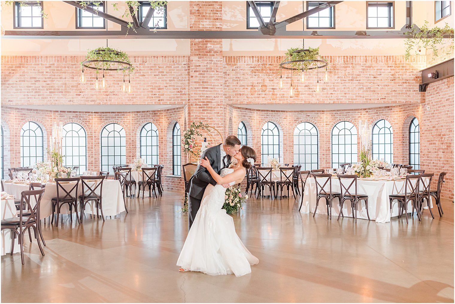 bride and groom kiss during industrial reception at The Refinery at Perona Farms