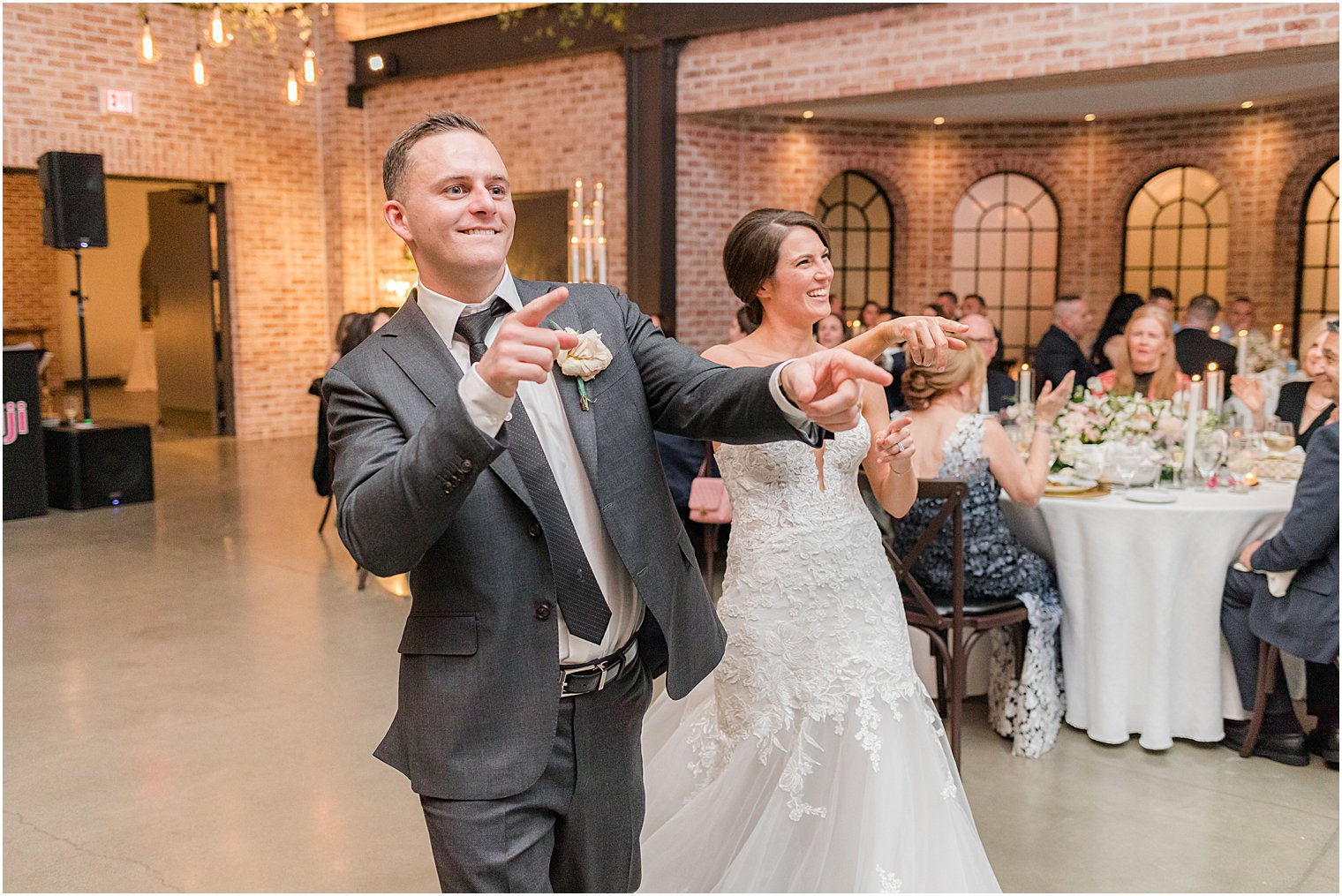 bride and groom walk into wedding reception