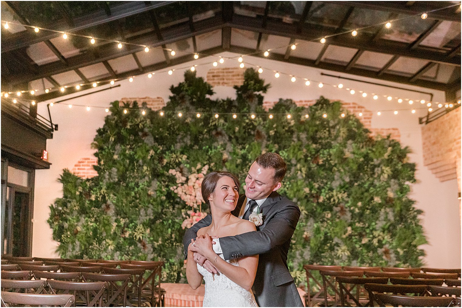 couple hugs during nighttime wedding portraits at The Refinery at Perona Farms