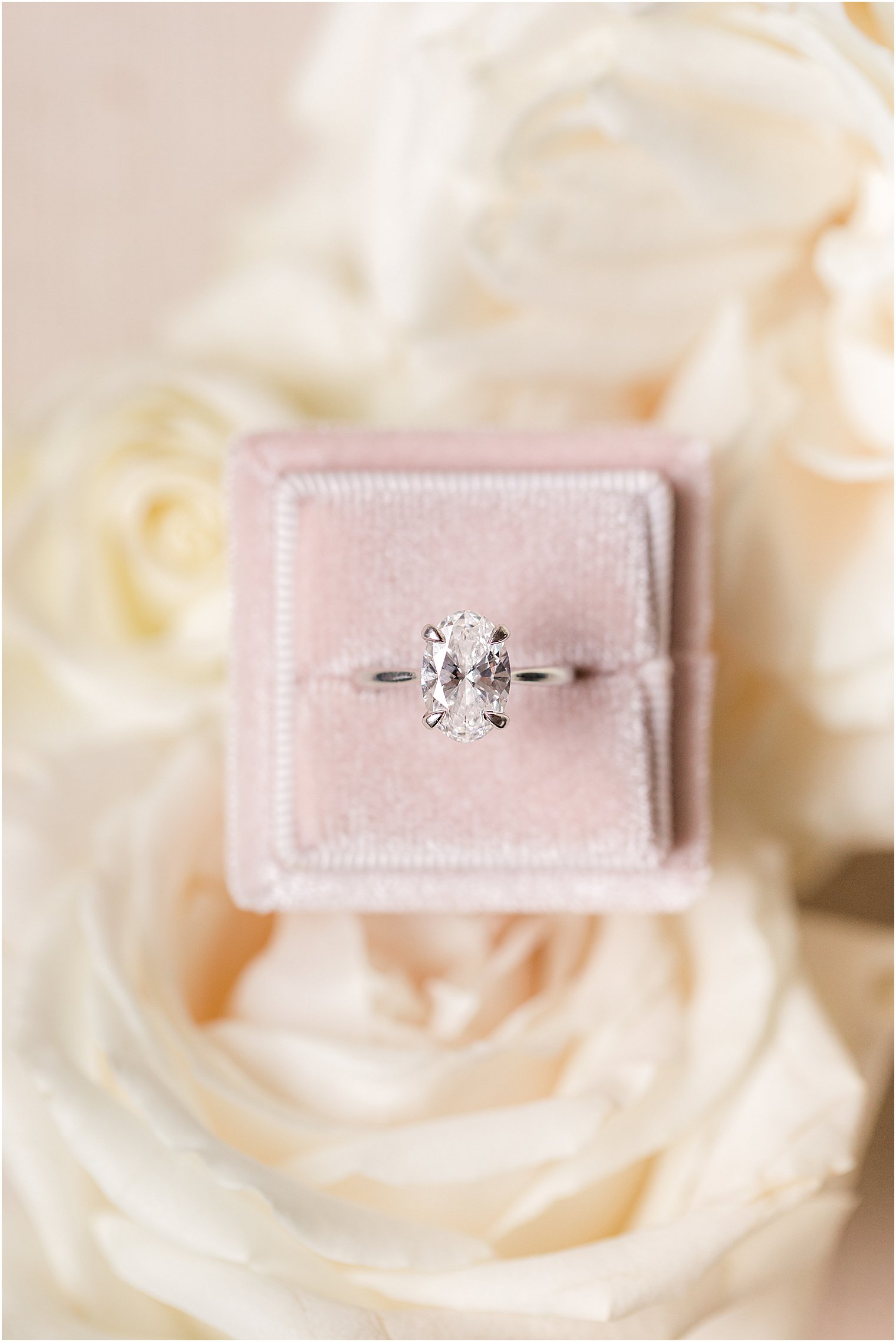 wedding ring rests in pale pink box