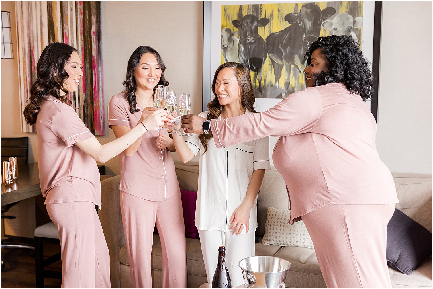 bride toasts champagne with bridesmaids 