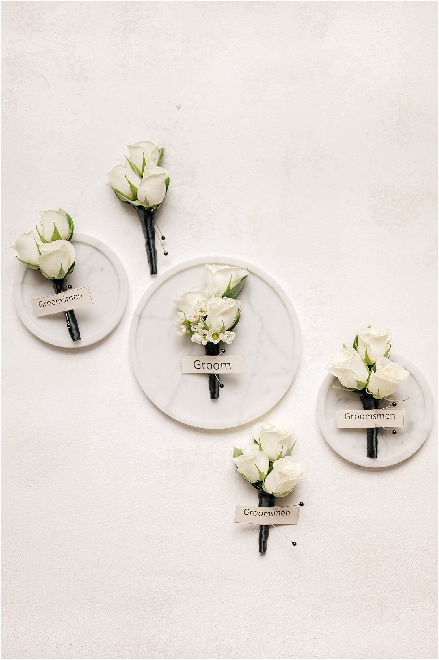 white boutonnieres for groom and groomsmen at The Lodge at Stirling Ridge