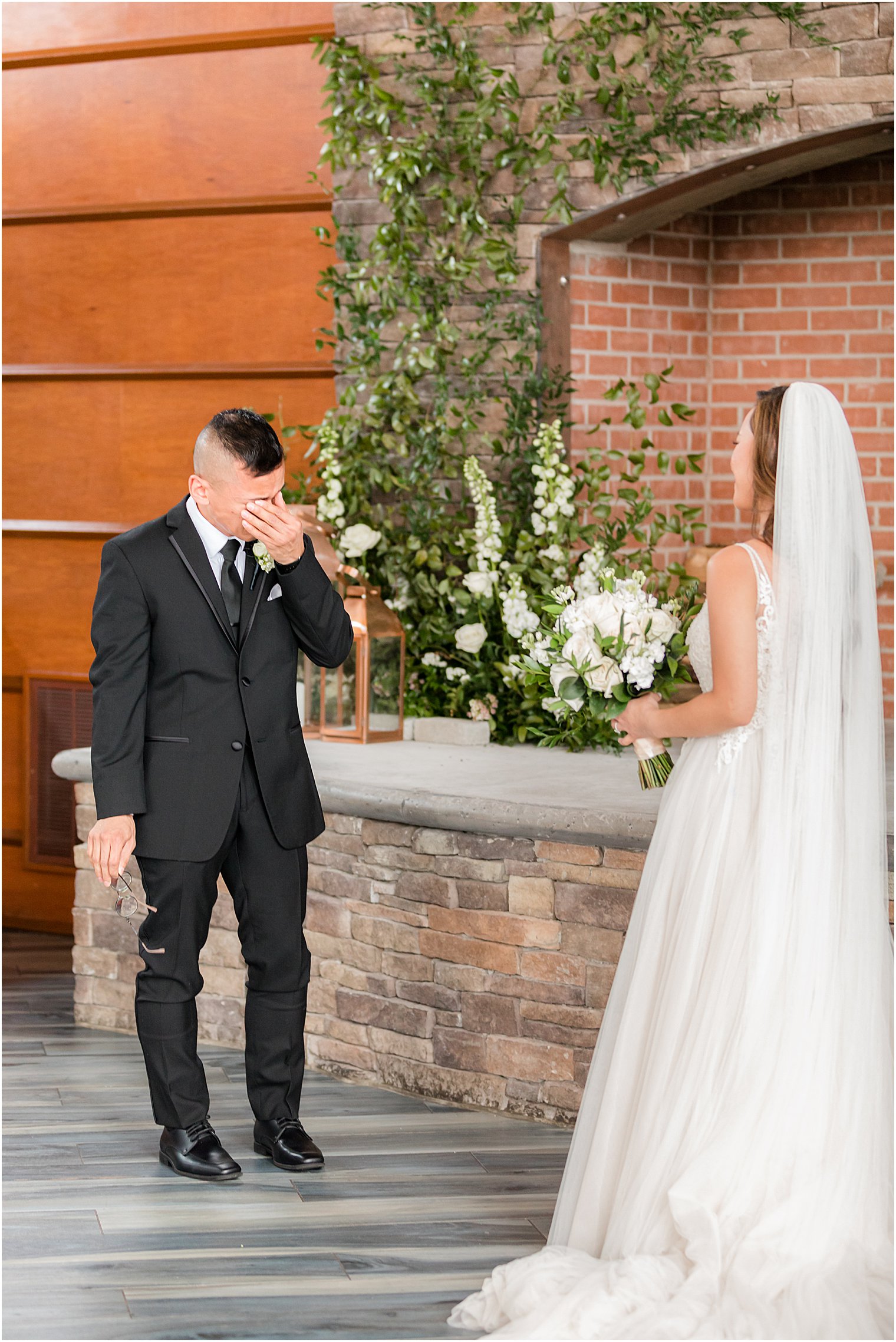 groom cries looking at bride during first look