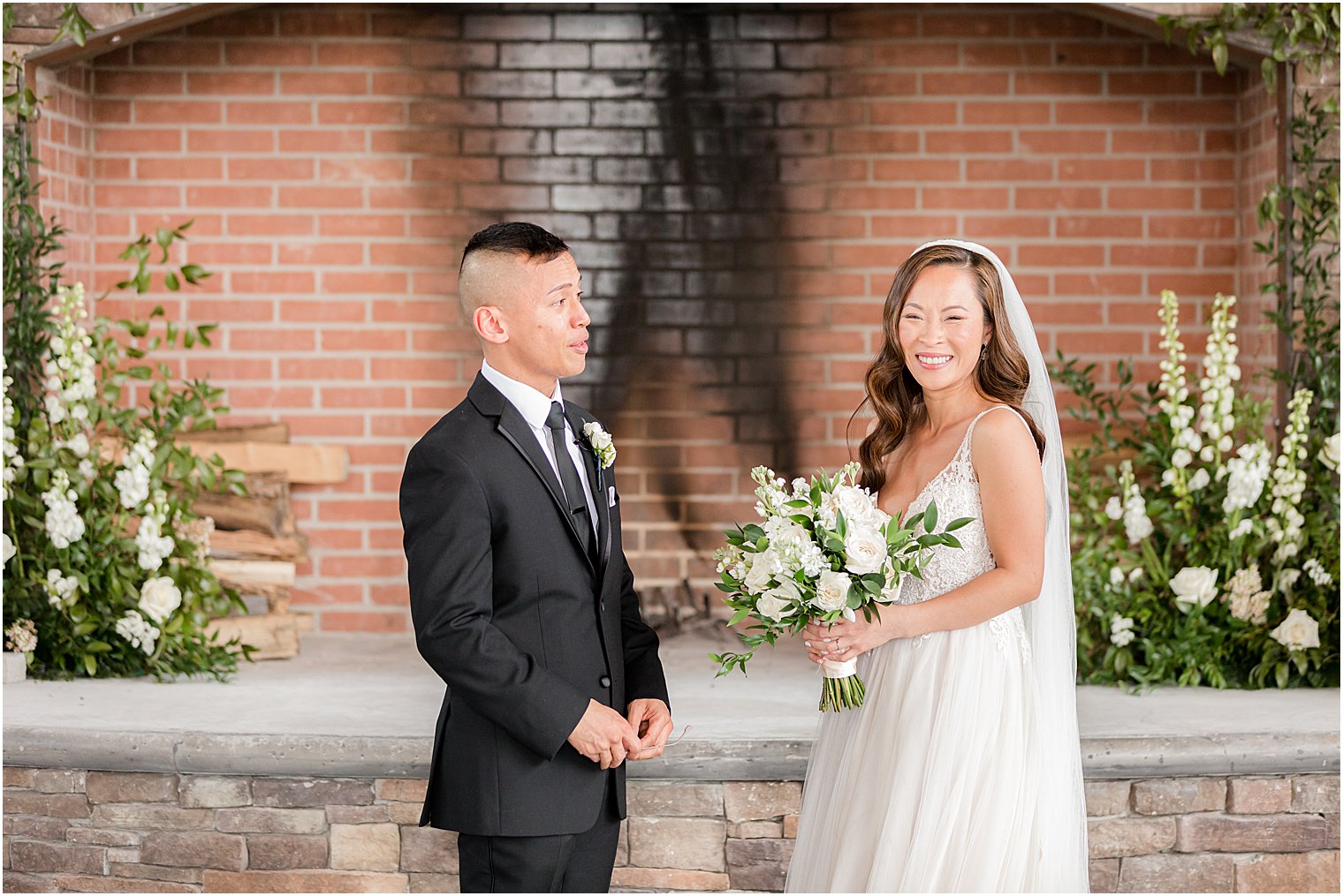 bride and groom laugh during first look