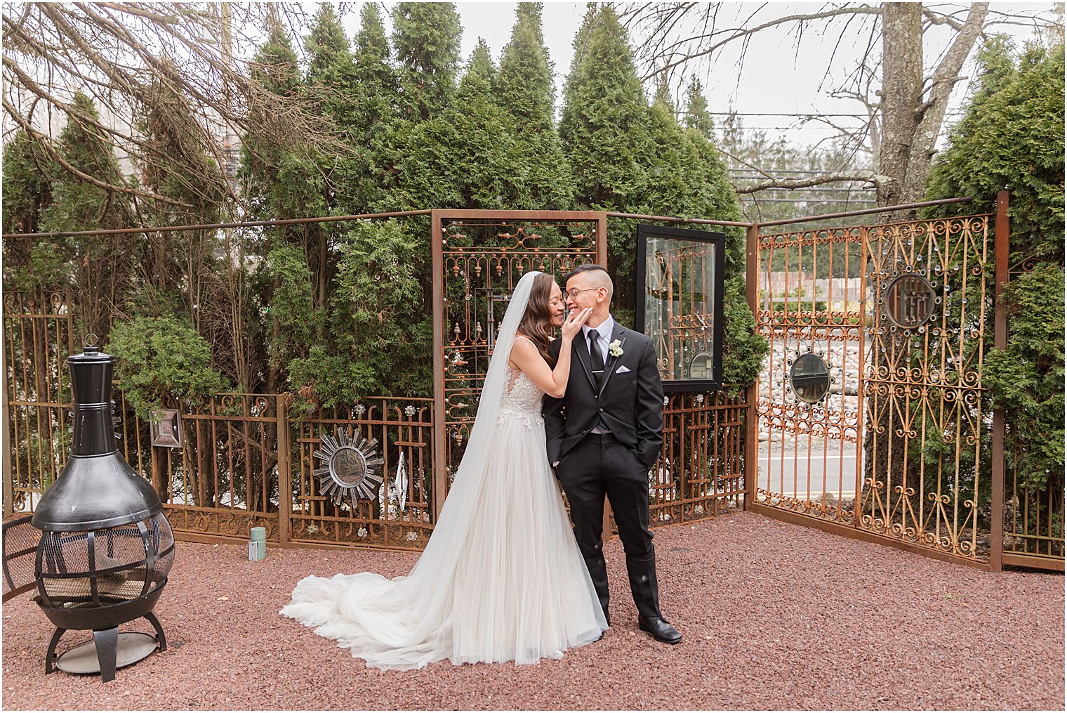 bride and groom pose on patio at The Lodge at Stirling Ridge