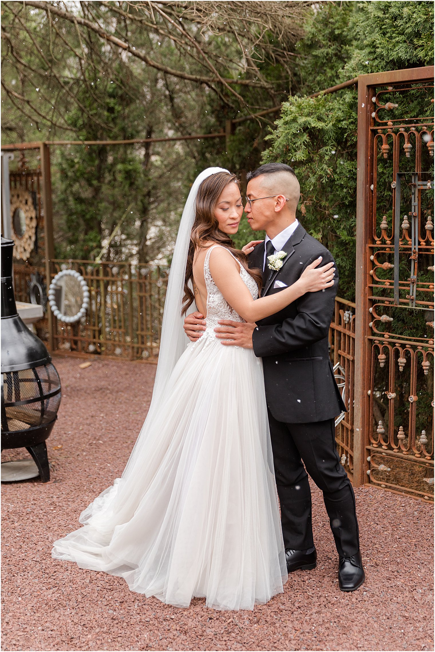 bride and groom hug during winter wedding portraits 