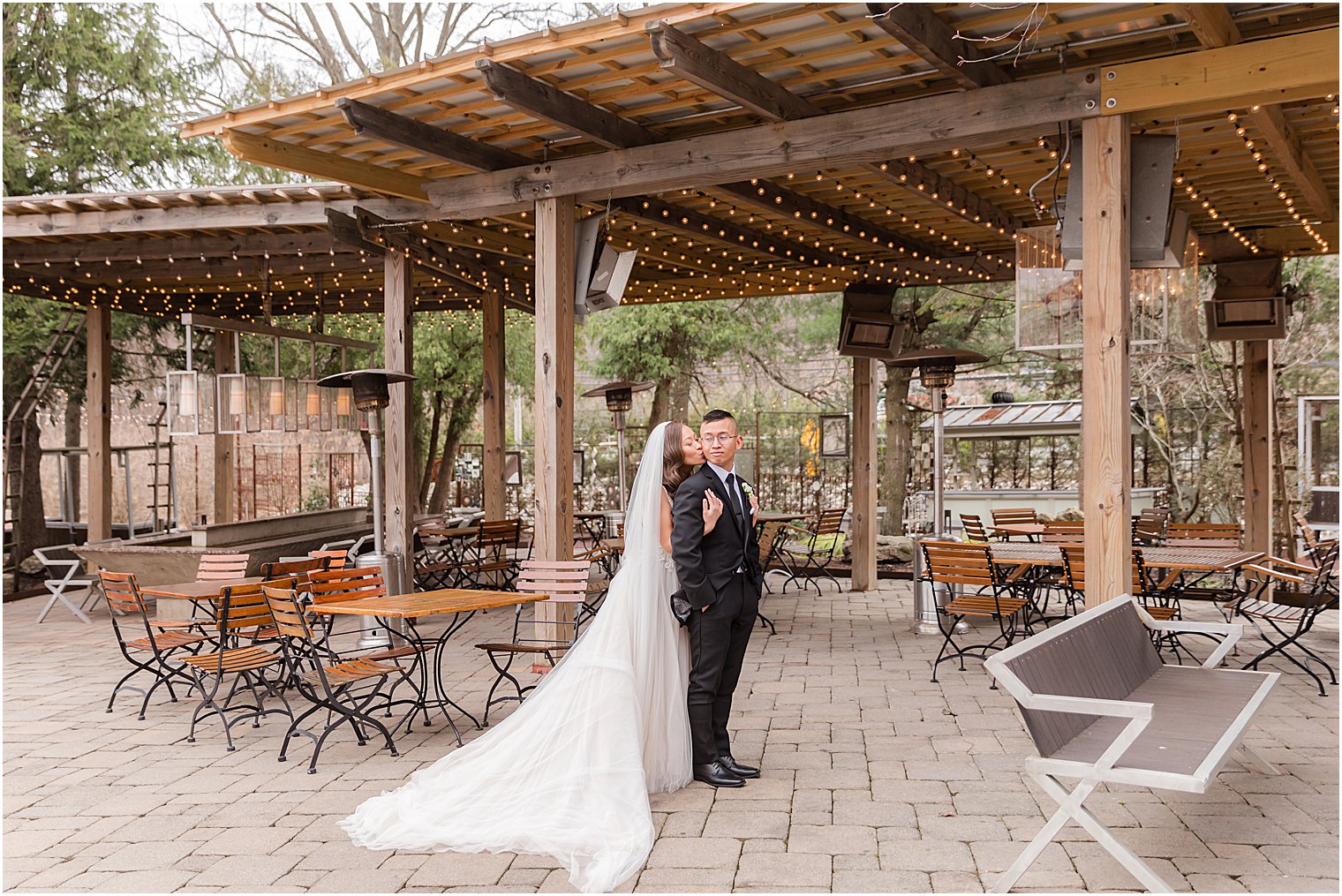 newlyweds pose on outdoor patio
