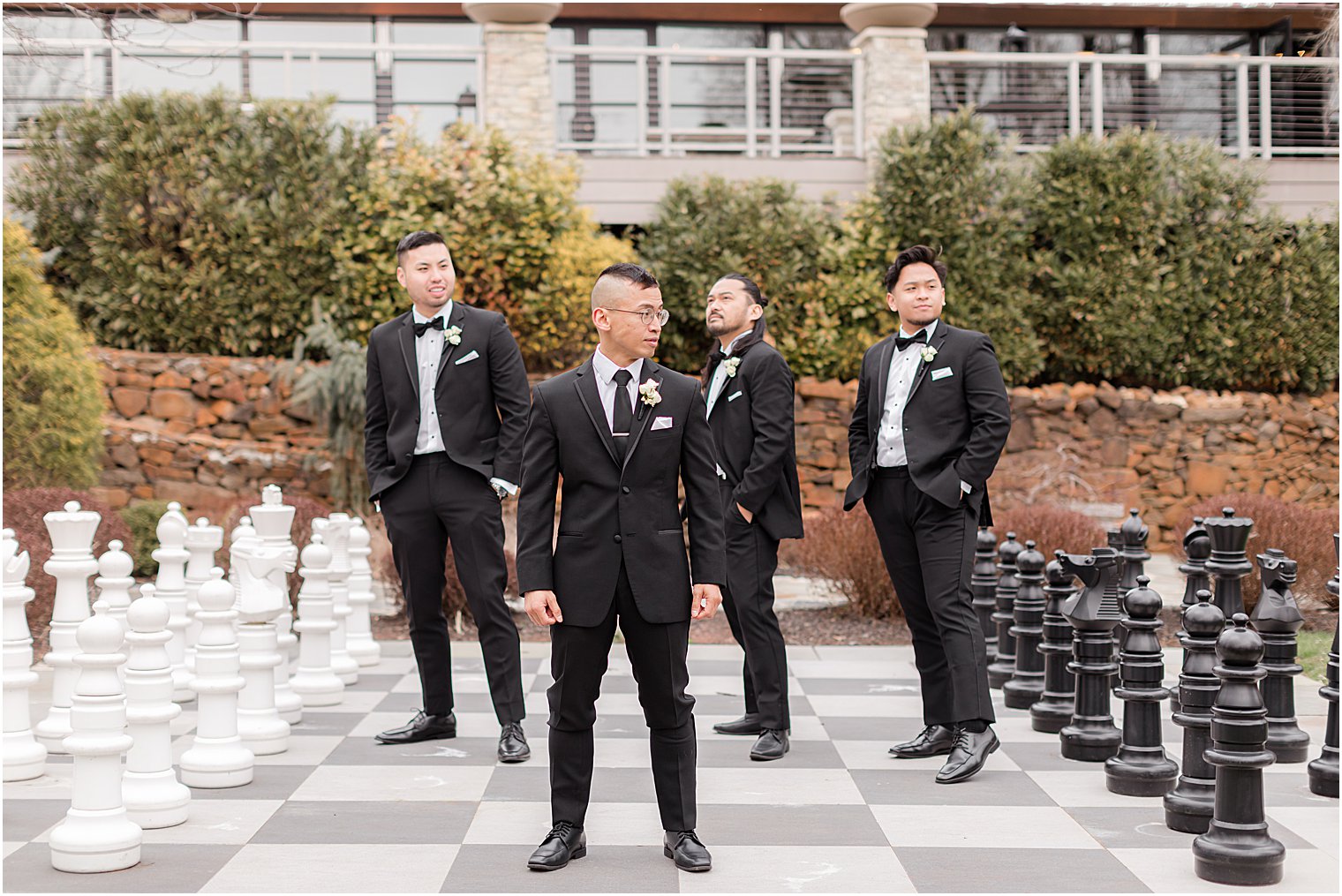 groom poses with groomsmen at The Lodge at Stirling Ridge