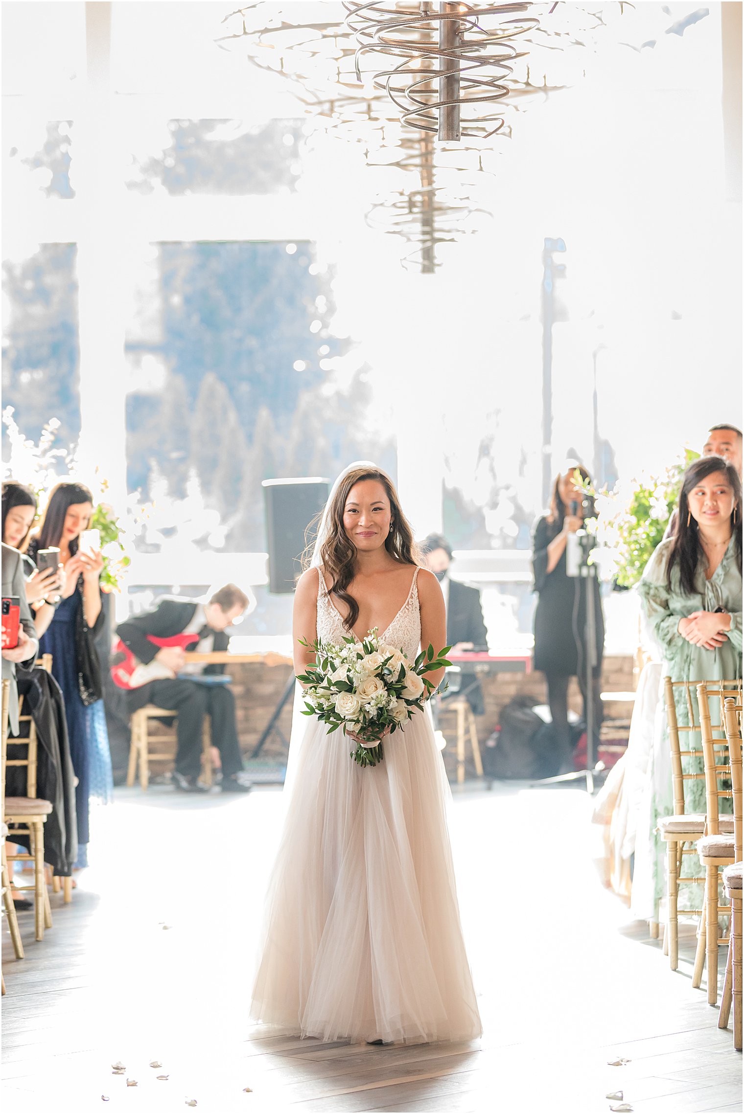 bride walks down aisle for ceremony at The Lodge at Stirling Ridge