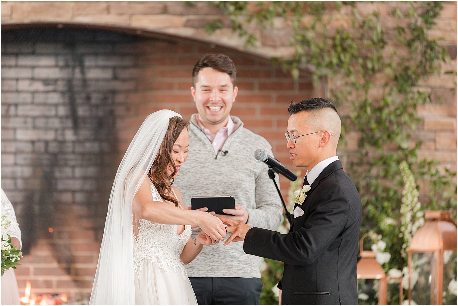 bride puts on ring during wedding ceremony