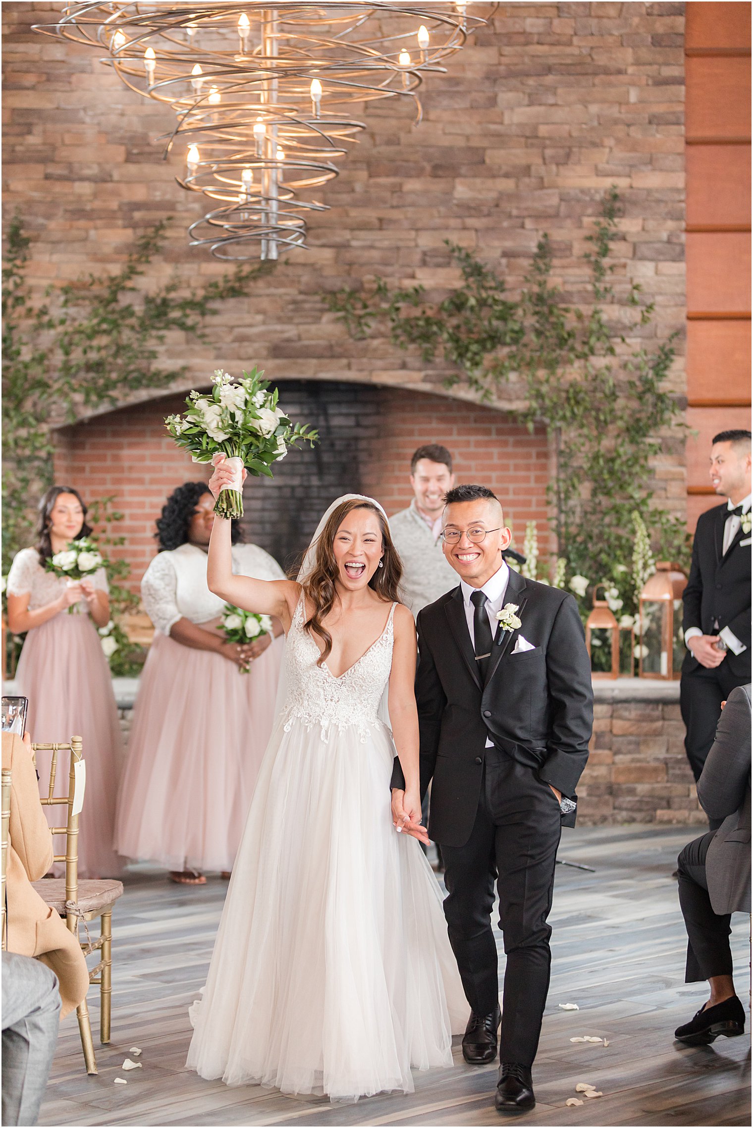 newlyweds walk up aisle at The Lodge at Stirling Ridge