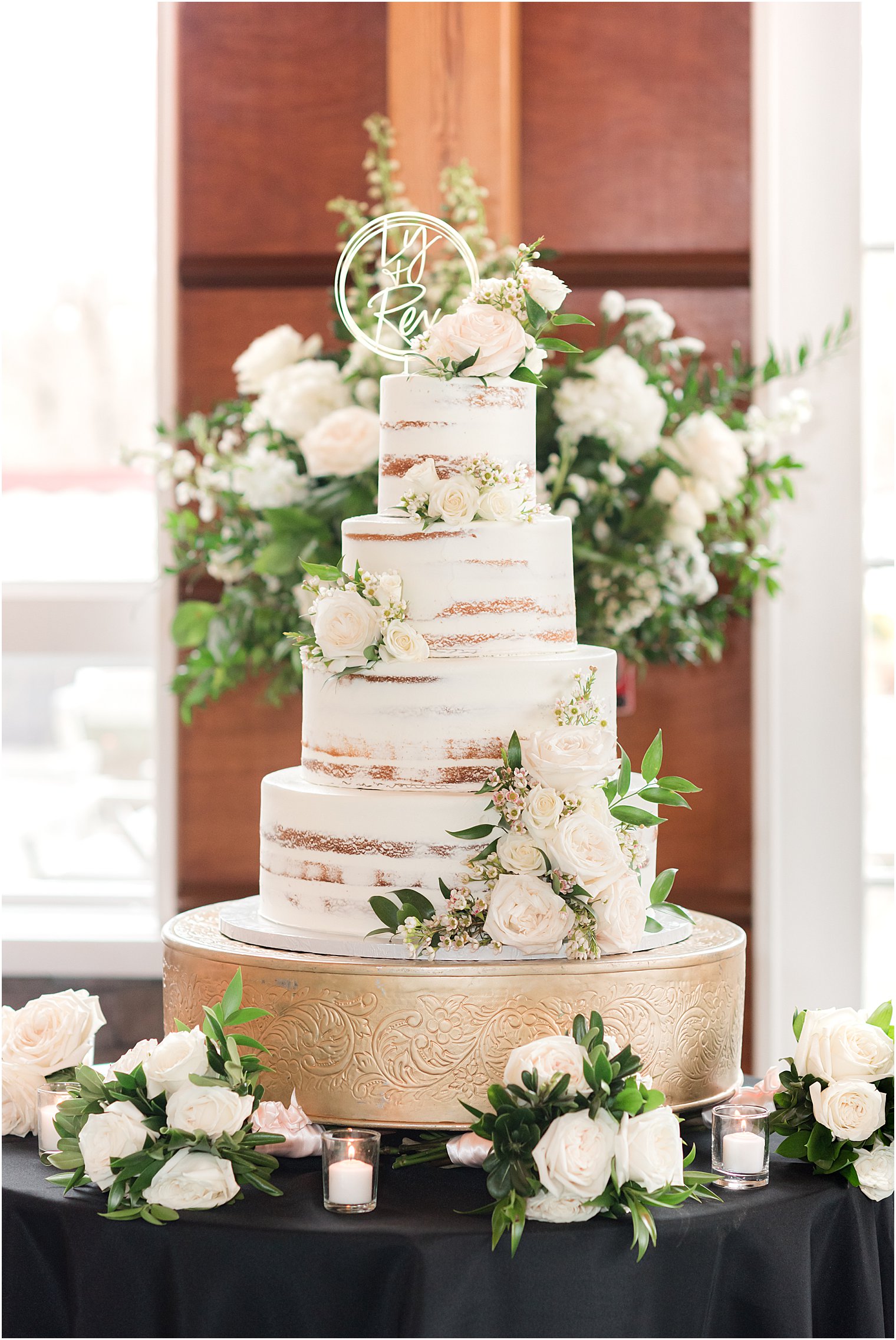 tiered wedding cake with gold and ivory details 