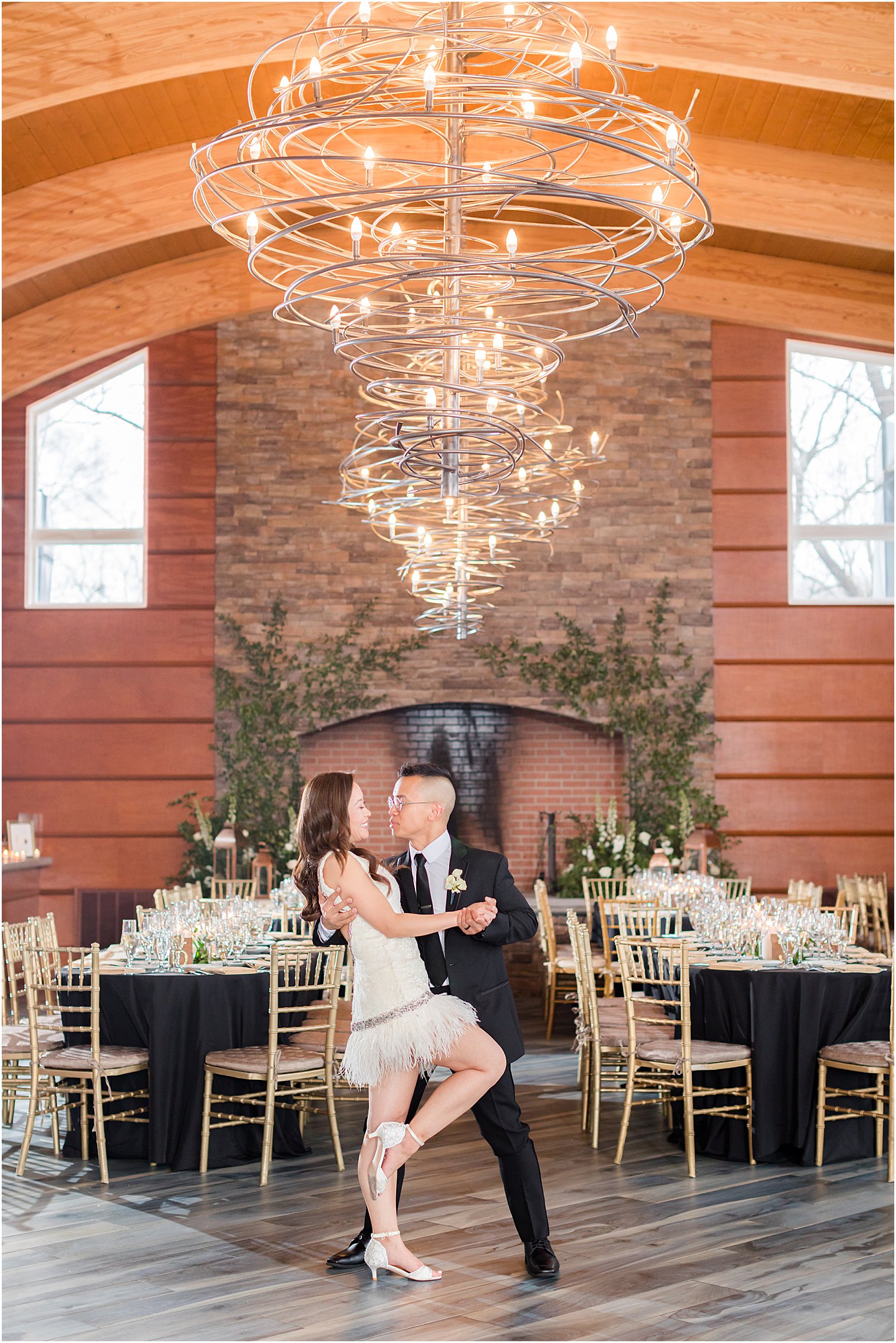 bride and groom kiss in reception space at The Lodge at Stirling Ridge