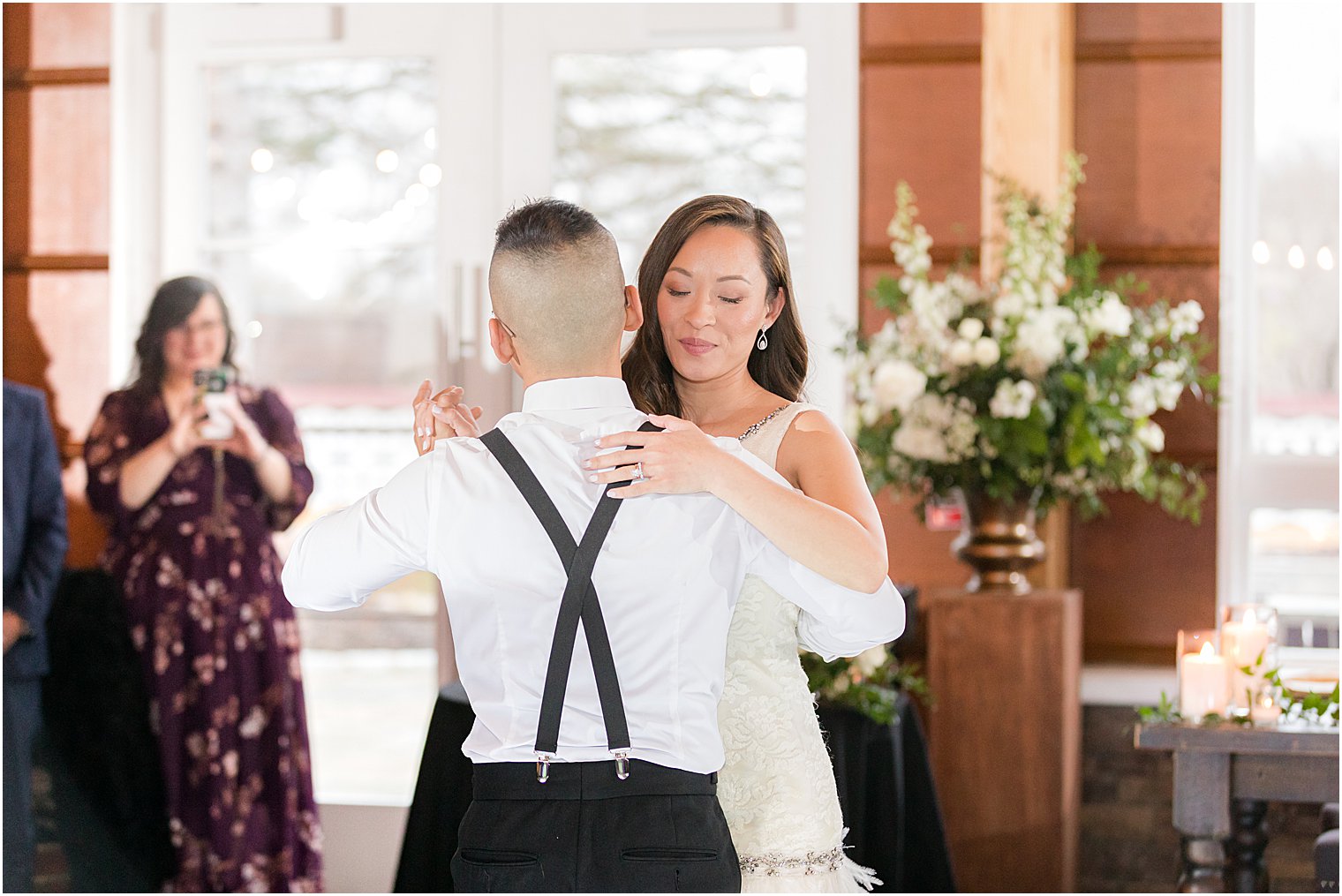 bride holds groom during first dance