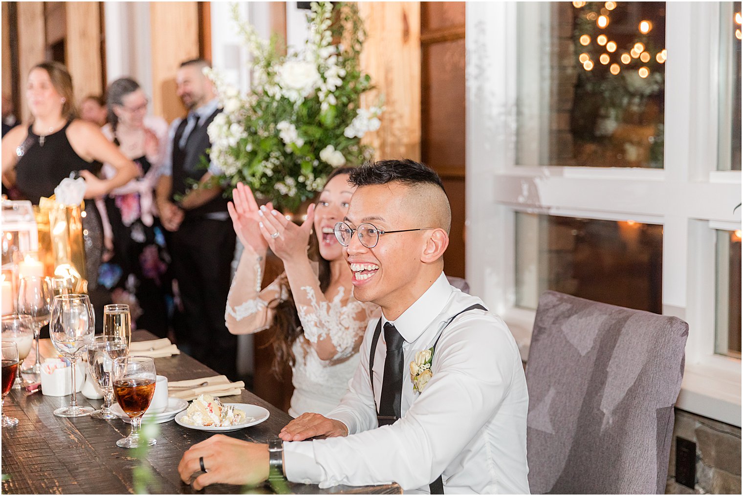 groom laughs during reception