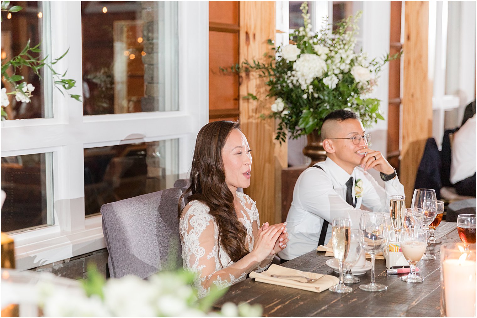 bride smiles watching NJ wedding reception 