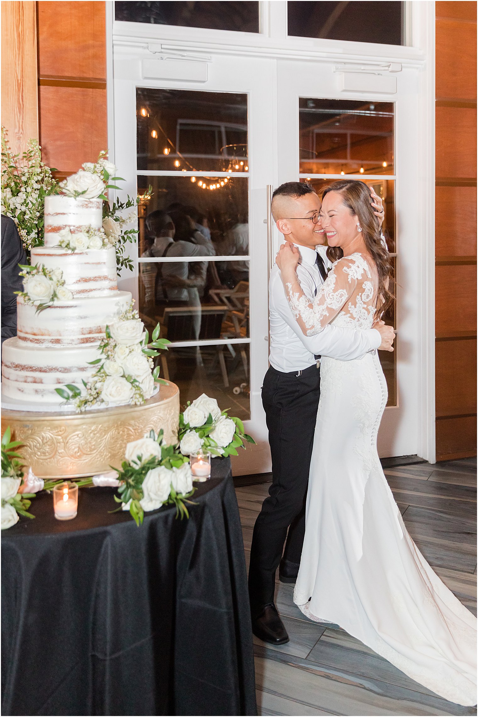 couple cuts wedding cake at wedding reception