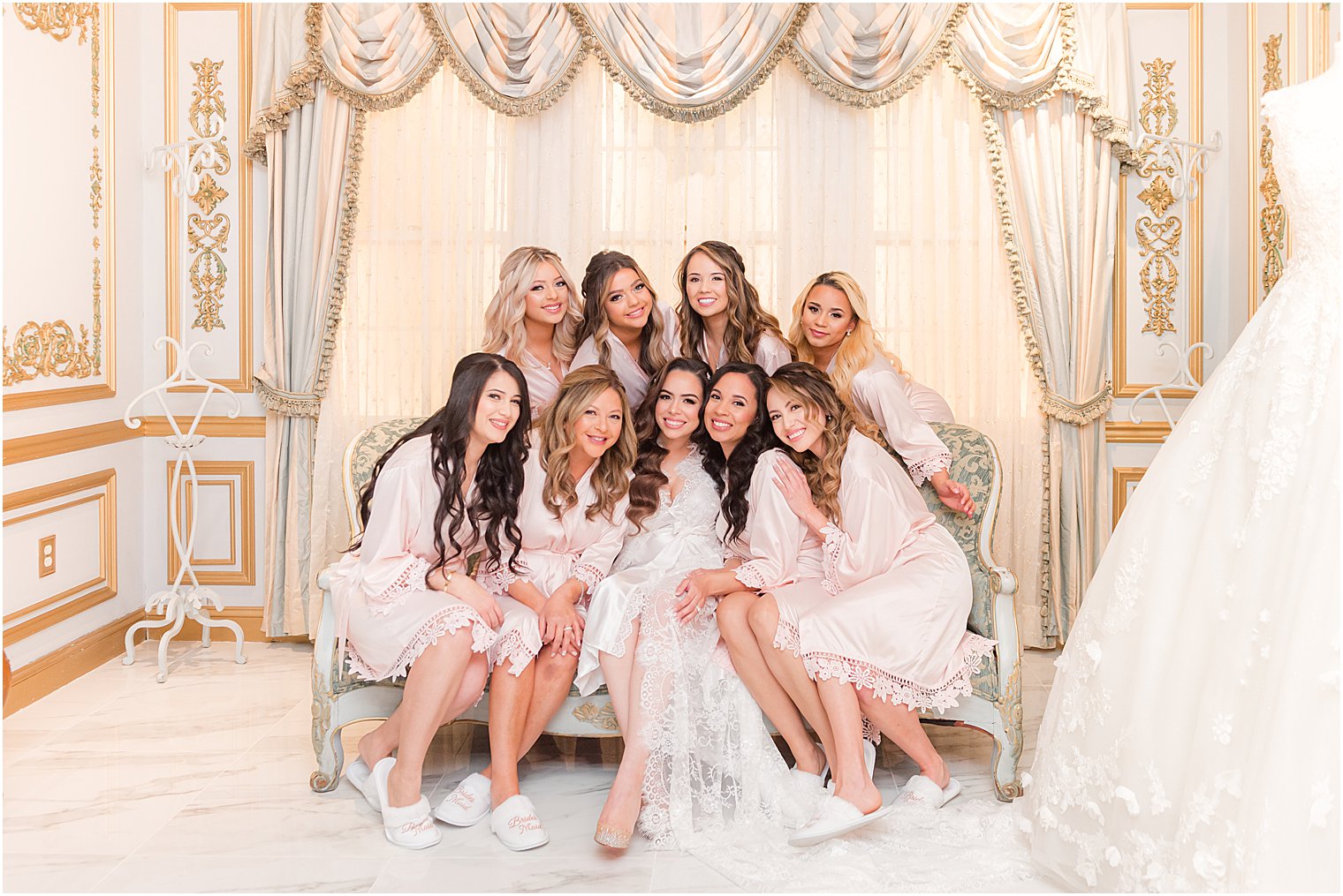 bridal party hugs bride during prep photos at The Manor