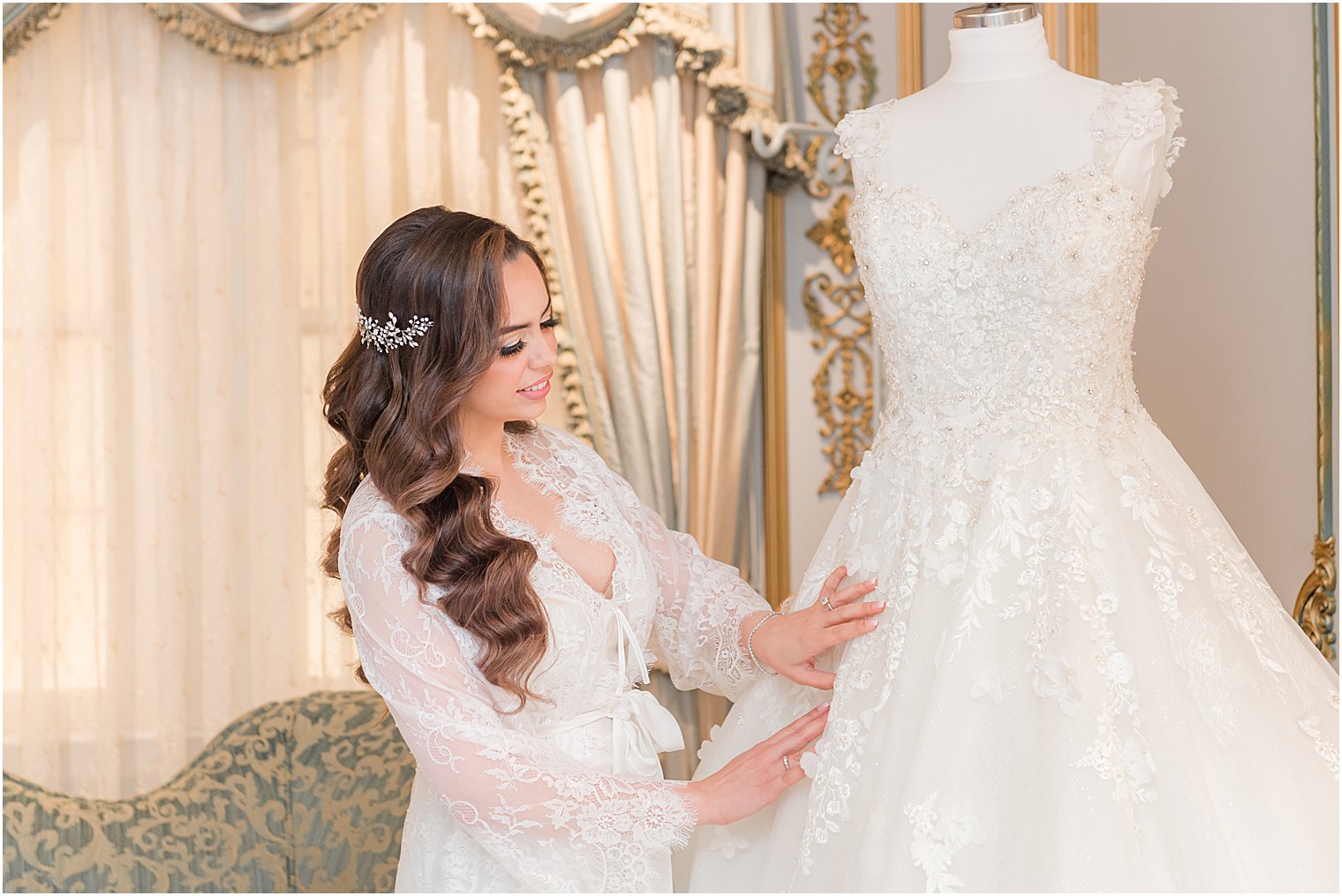 bride looks at wedding gown during prep at The Manor in West Orange NJ
