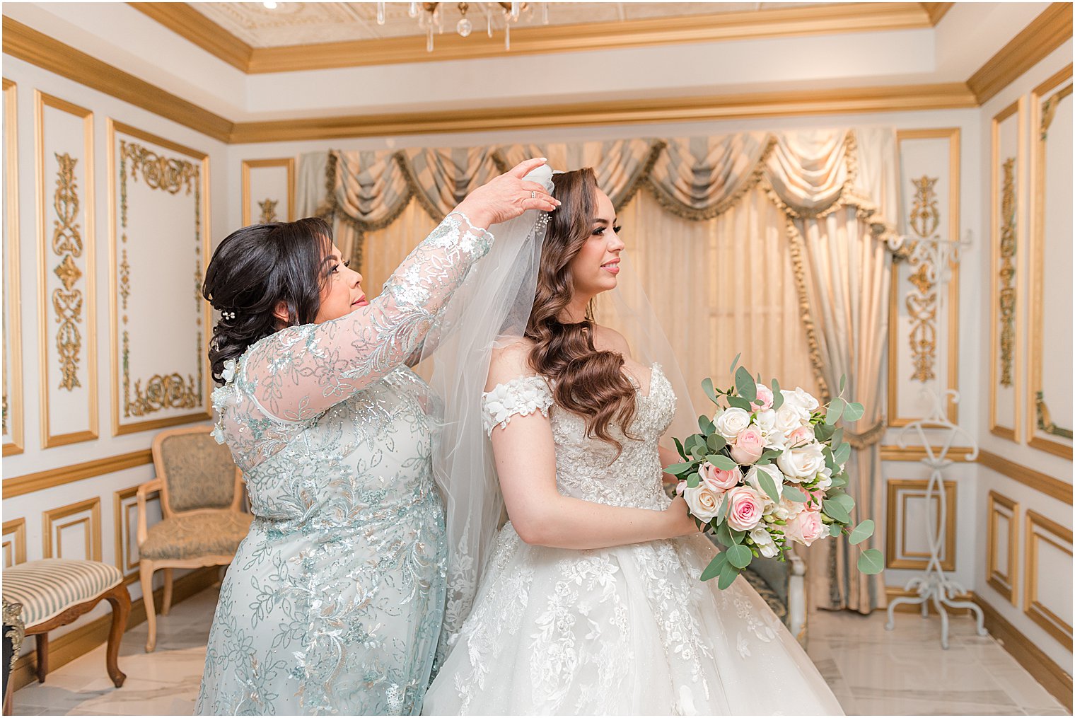 mother helps bride with veil at The Manor
