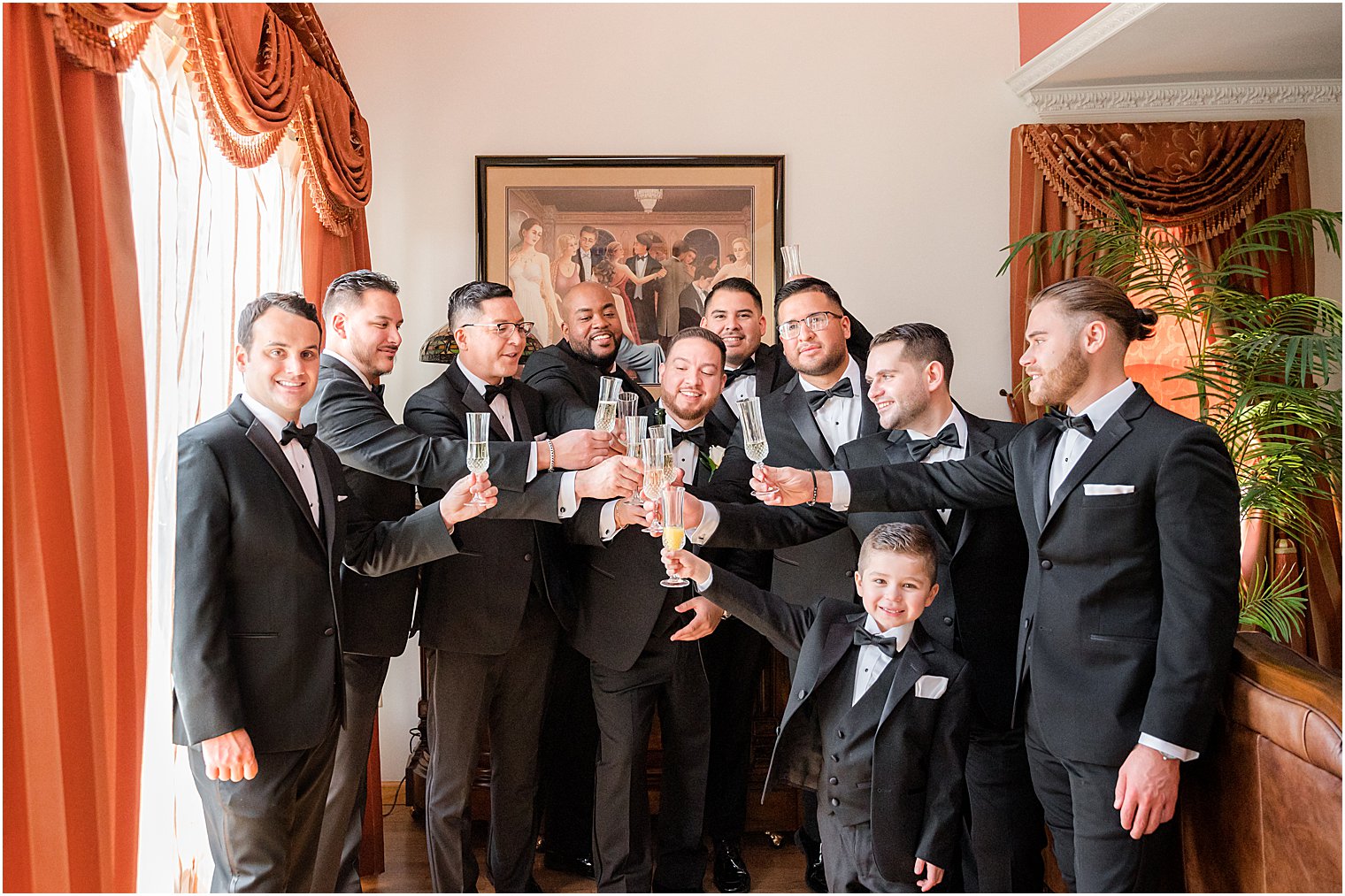 groom laughs with groomsmen at home