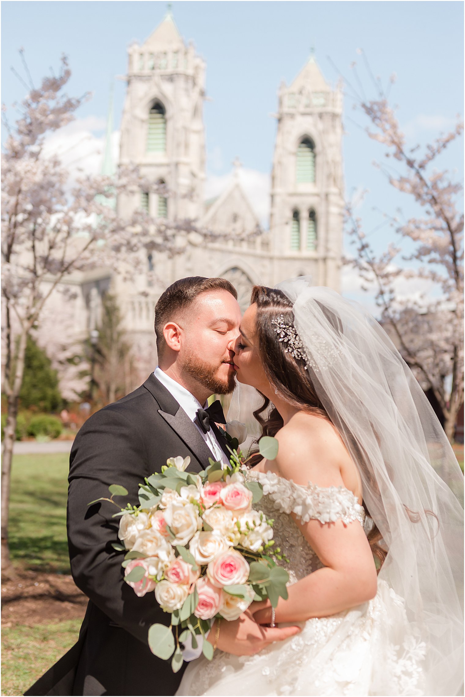 bride and groom kiss in front of Cathedral Basilica of the Sacred Heart in Newark NJ