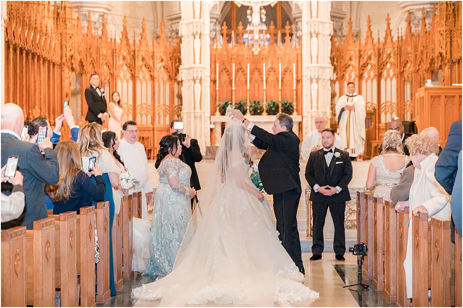 dad lifts bride's veil during Catholic wedding ceremony at Cathedral Basilica of the Sacred Heart