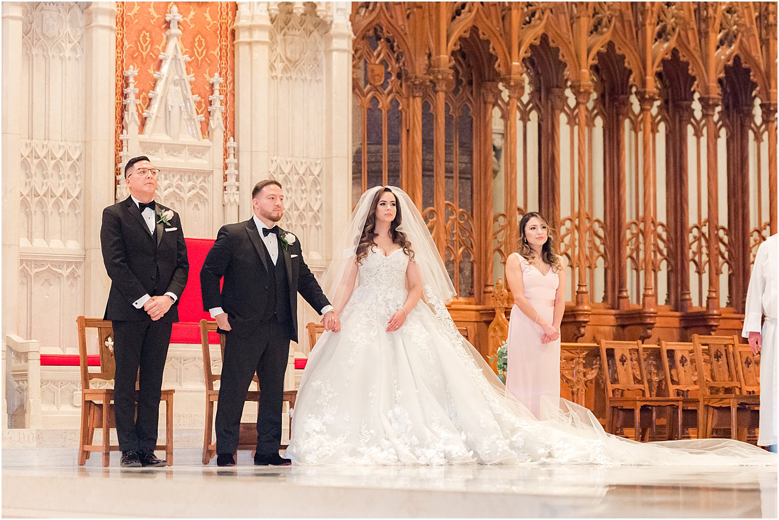 bride and groom stand at altar during Catholic wedding ceremony at Cathedral Basilica of the Sacred Heart