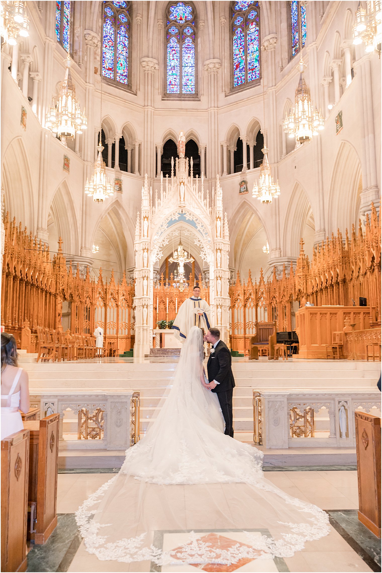couple kisses during Catholic wedding ceremony at Cathedral Basilica of the Sacred Heart