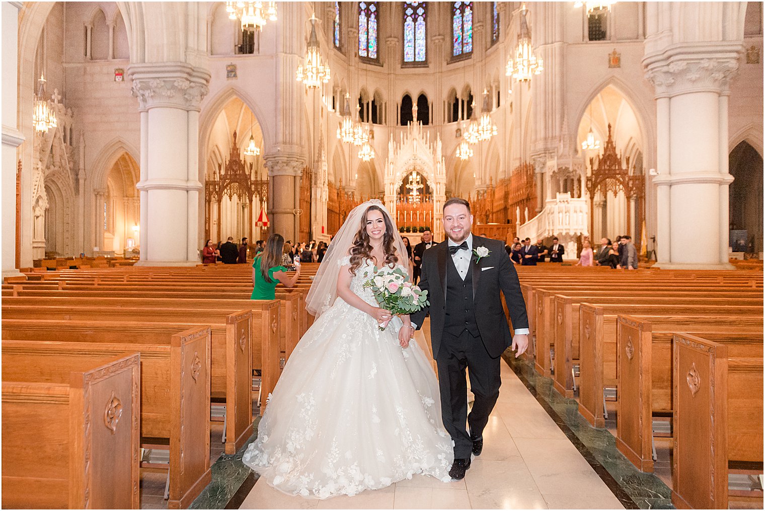 couple walks up aisle after Catholic wedding ceremony at Cathedral Basilica of the Sacred Heart