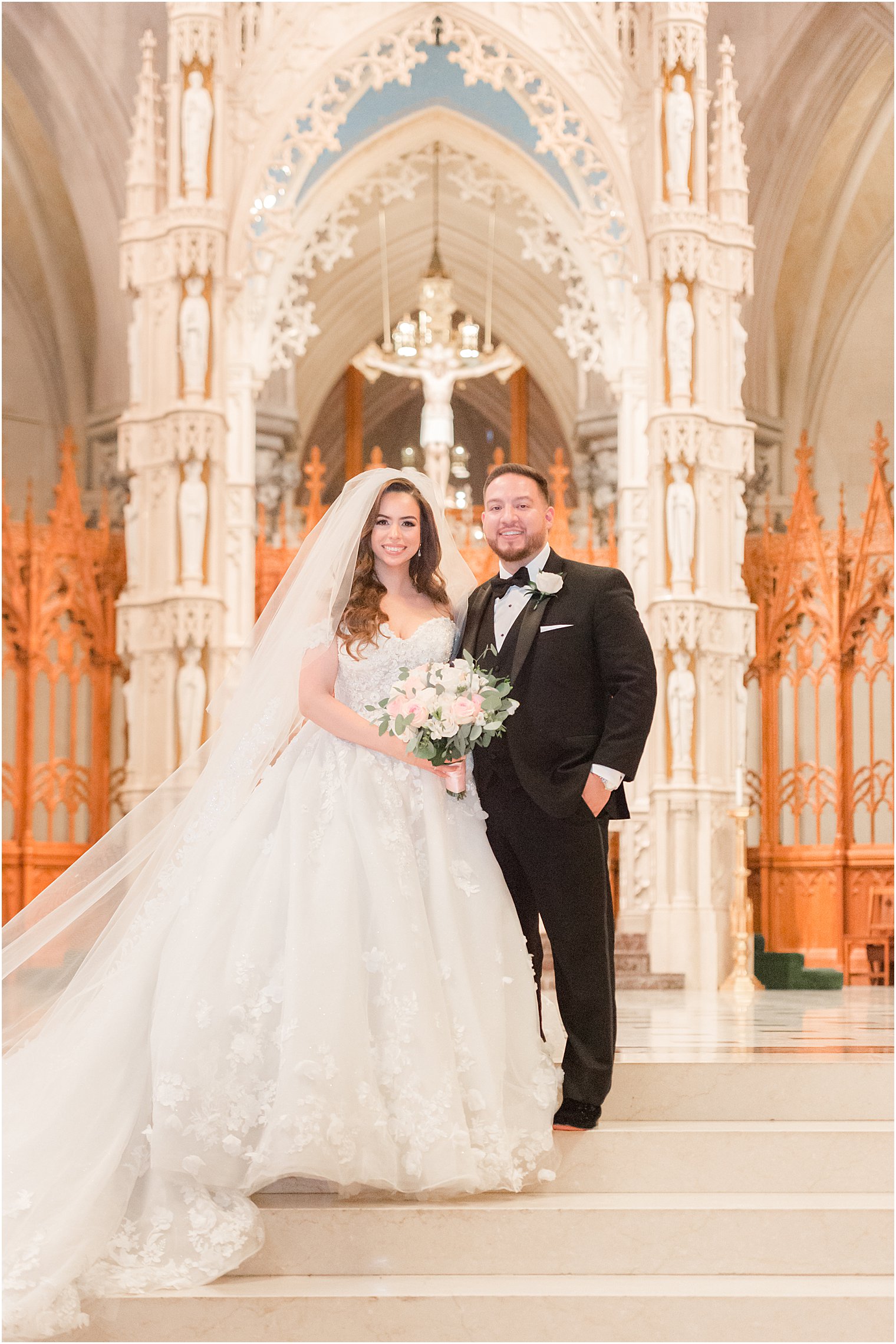 bride and groom stand at altar of Cathedral Basilica of the Sacred Heart