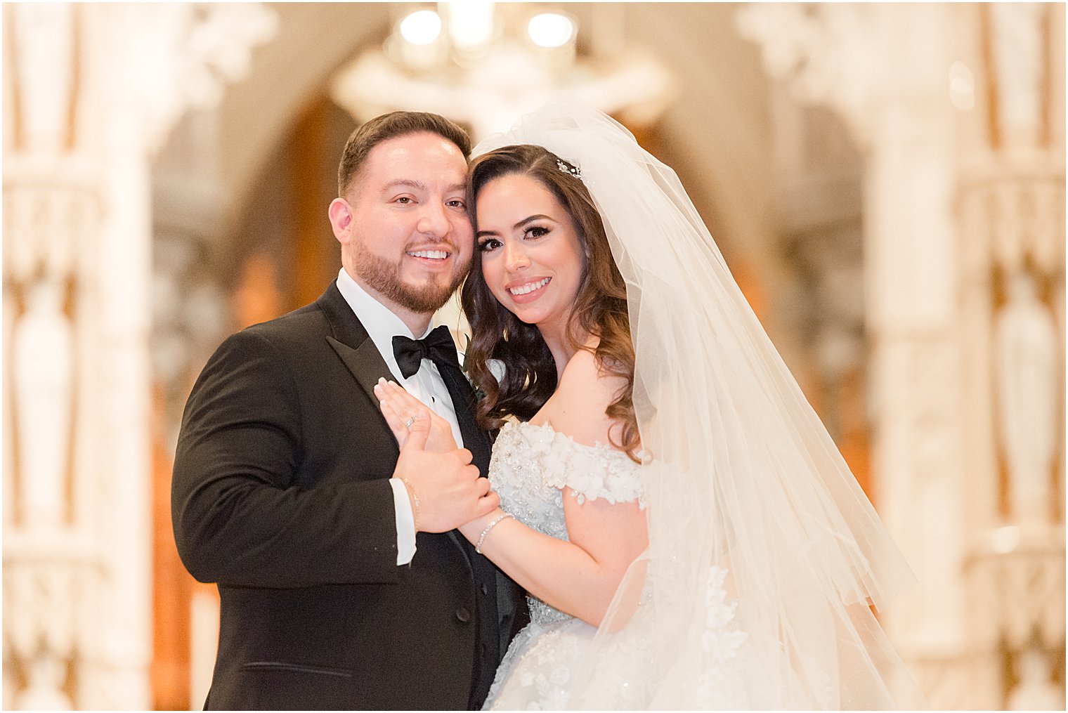 newlyweds stand together hugging in the Cathedral Basilica of the Sacred Heart