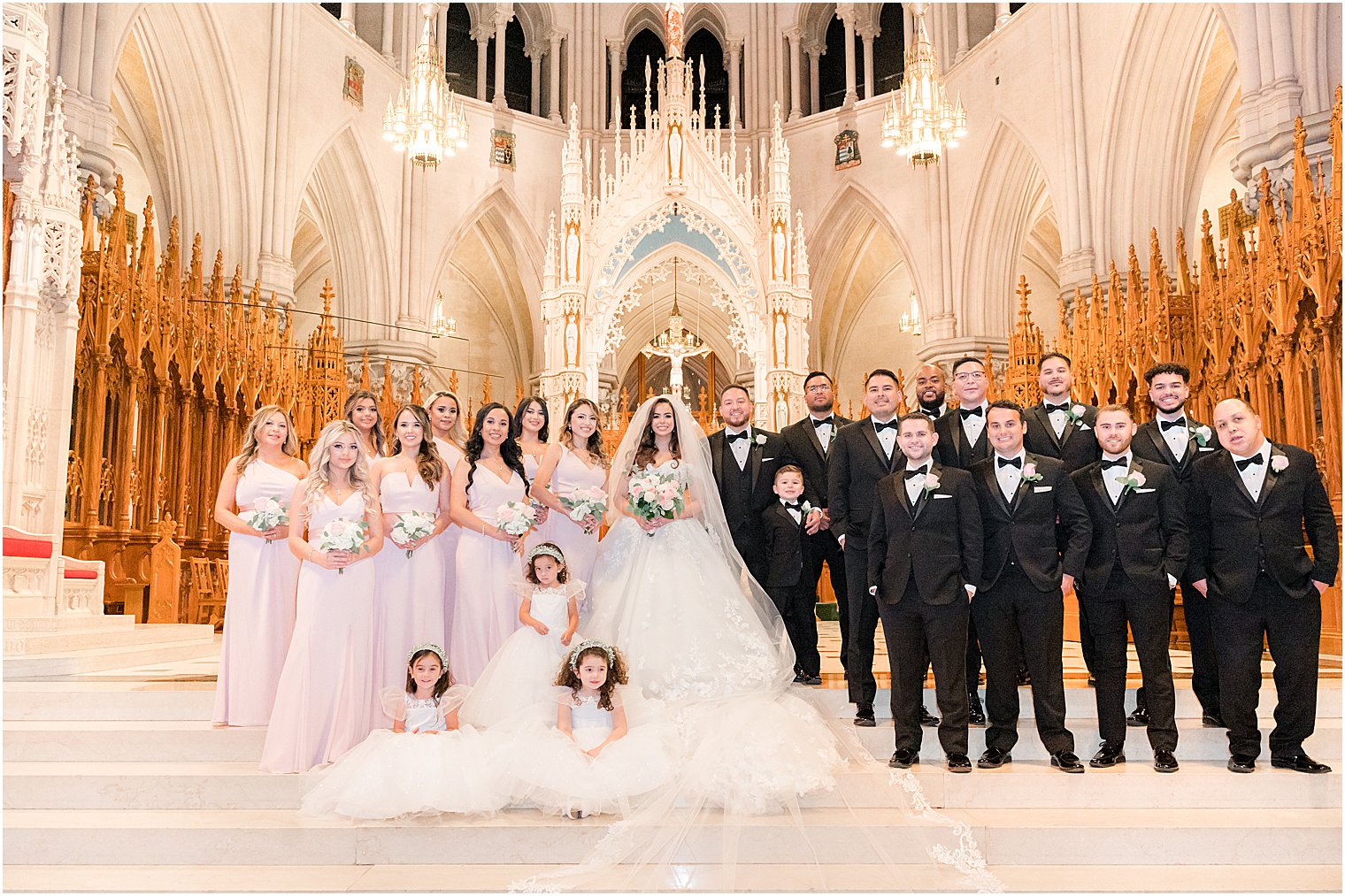 bride and groom stand with wedding party inside the Cathedral Basilica of the Sacred Heart