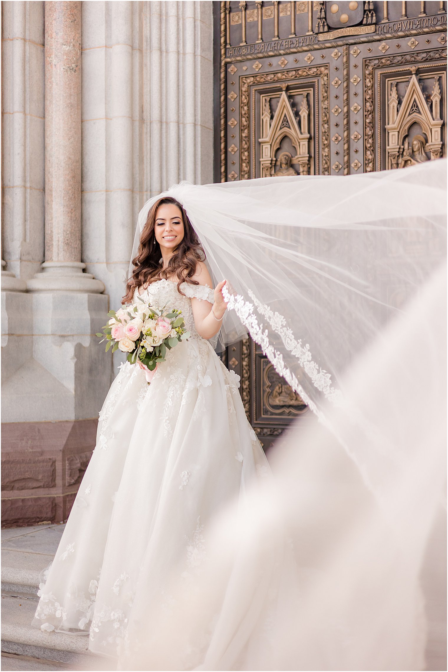 bridal portrait with veil floating outside the Cathedral Basilica of the Sacred Heart