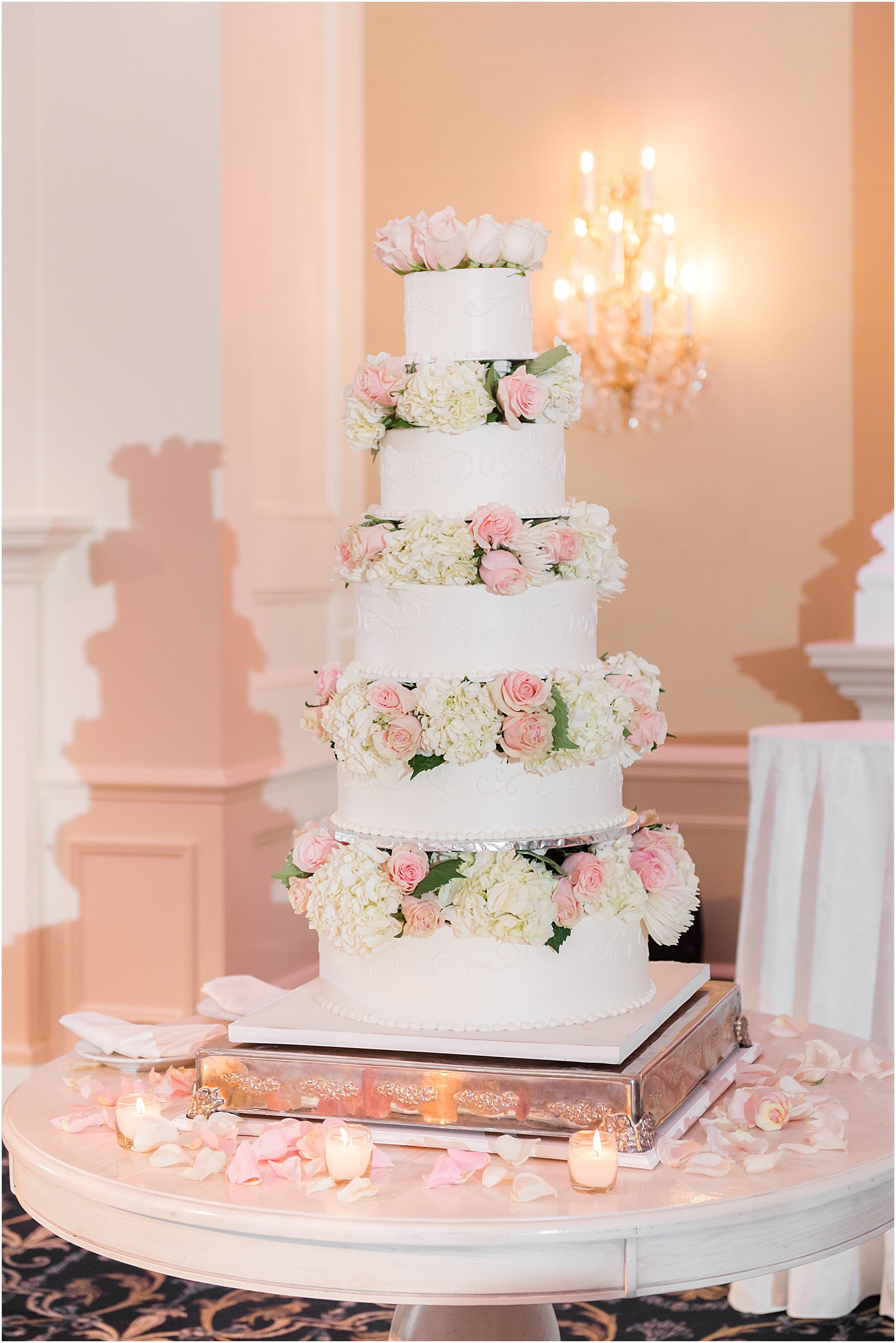 tiered wedding cake with pink and white flowers 