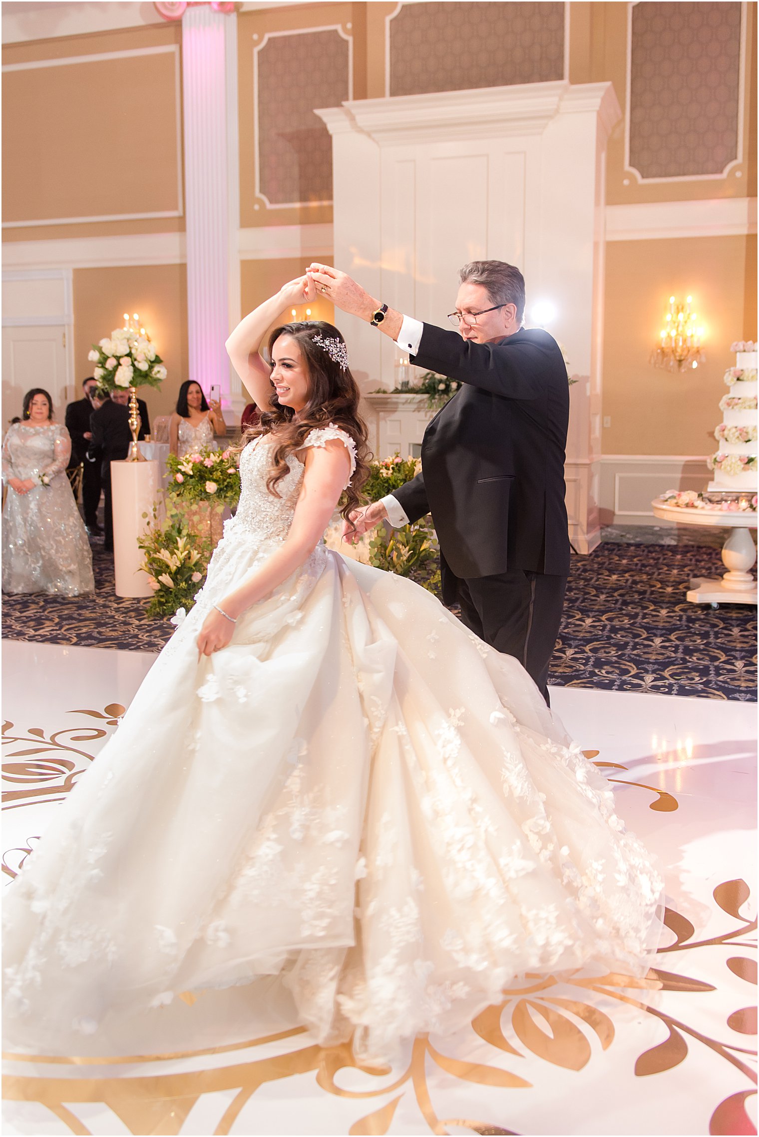 dad twirls bride with ballroom wedding gown 