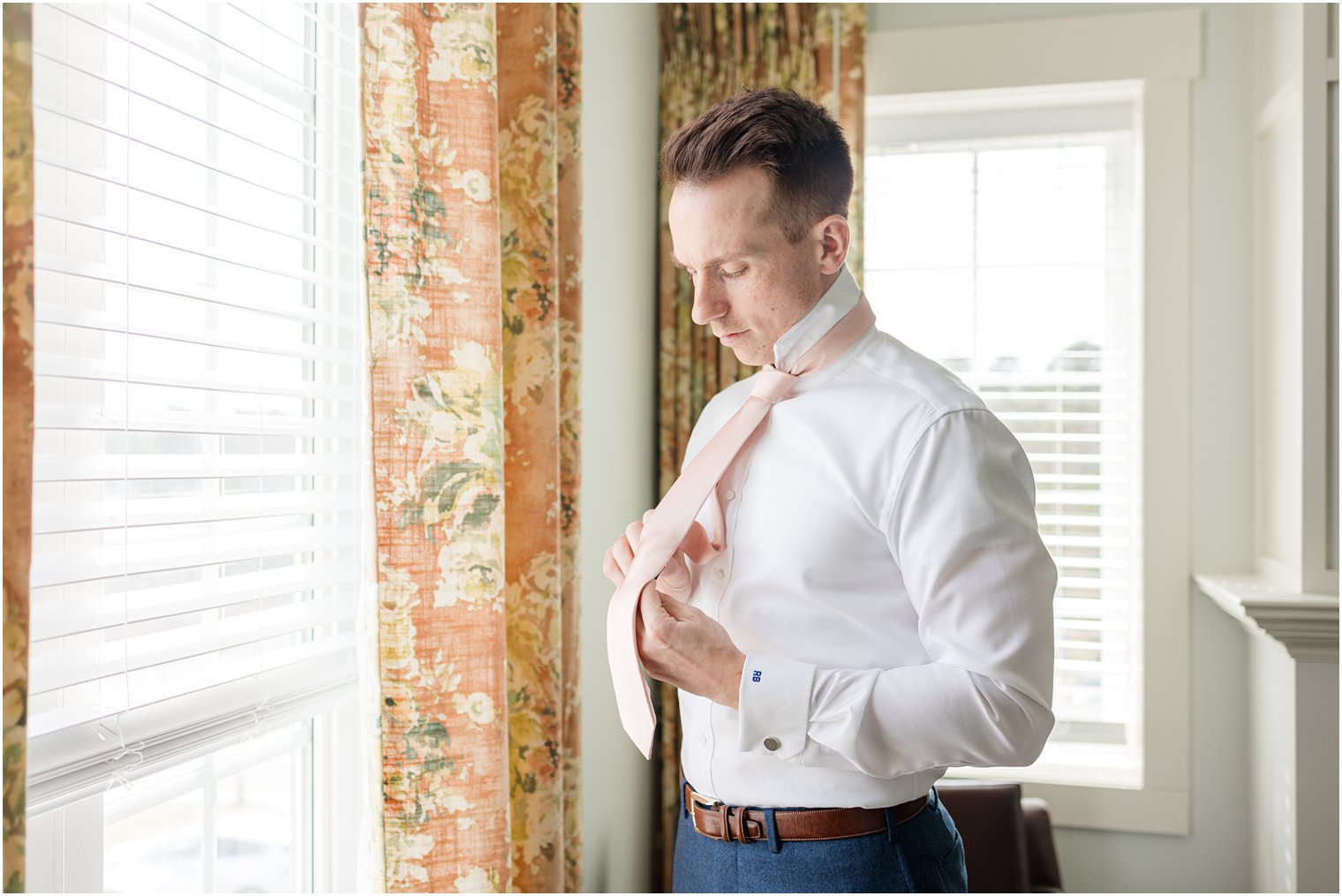 groom putting on tie at Renault Winery in Egg Harbor Township, NJ