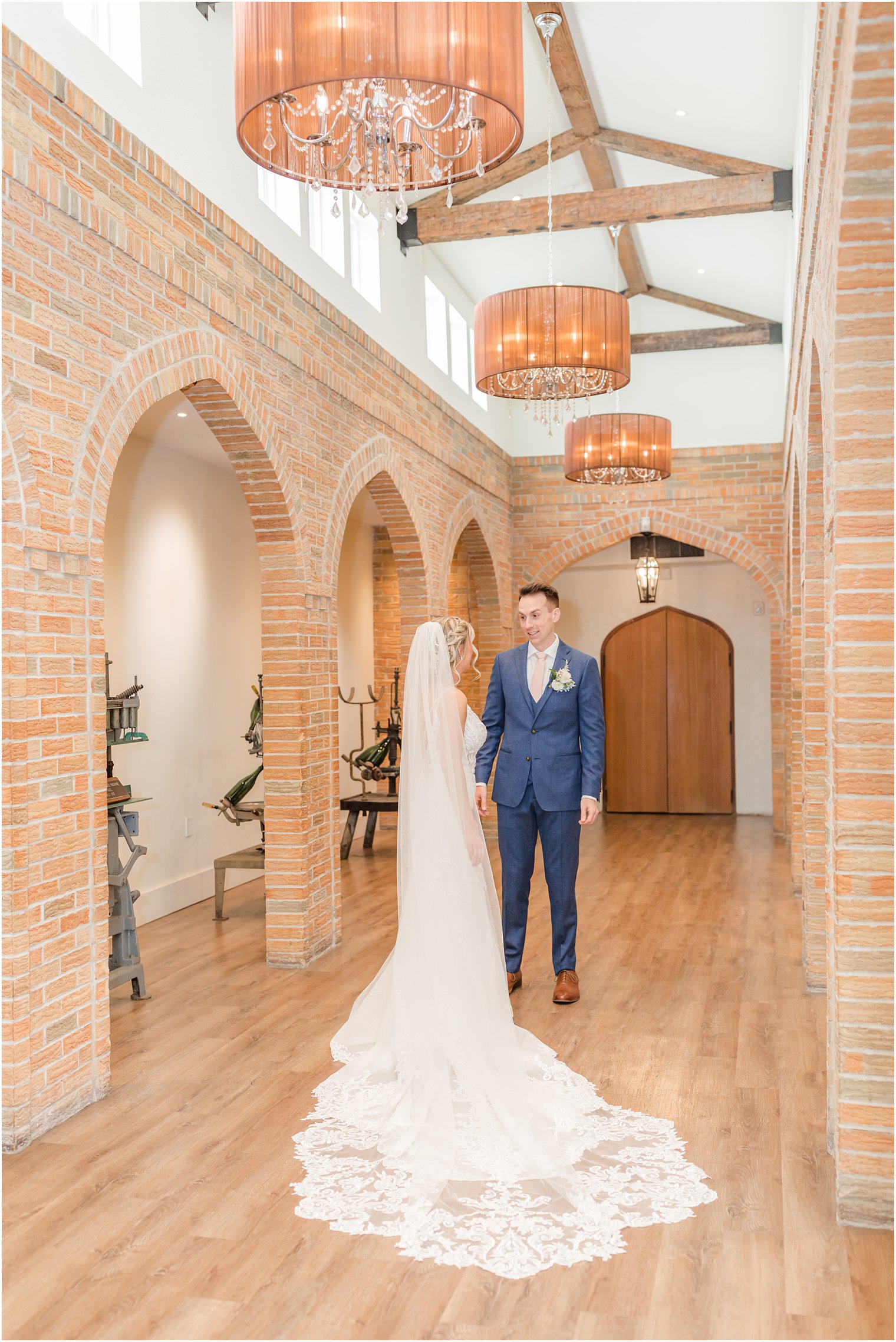 groom seeing bride at first look in wine cellar at Renault Winery in Egg Harbor Township, NJ