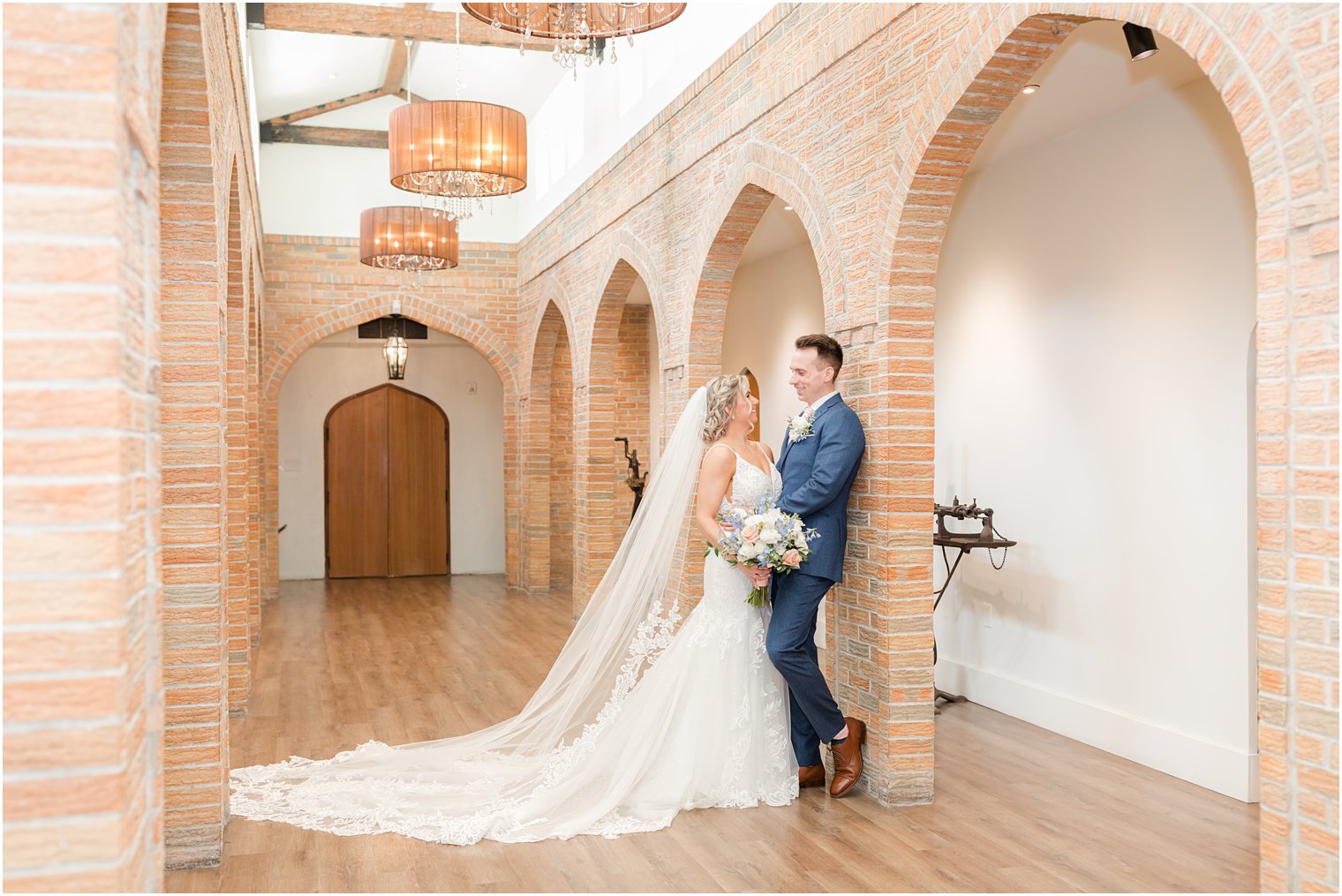 bride and groom at first look in wine cellar at Renault Winery in Egg Harbor Township, NJ