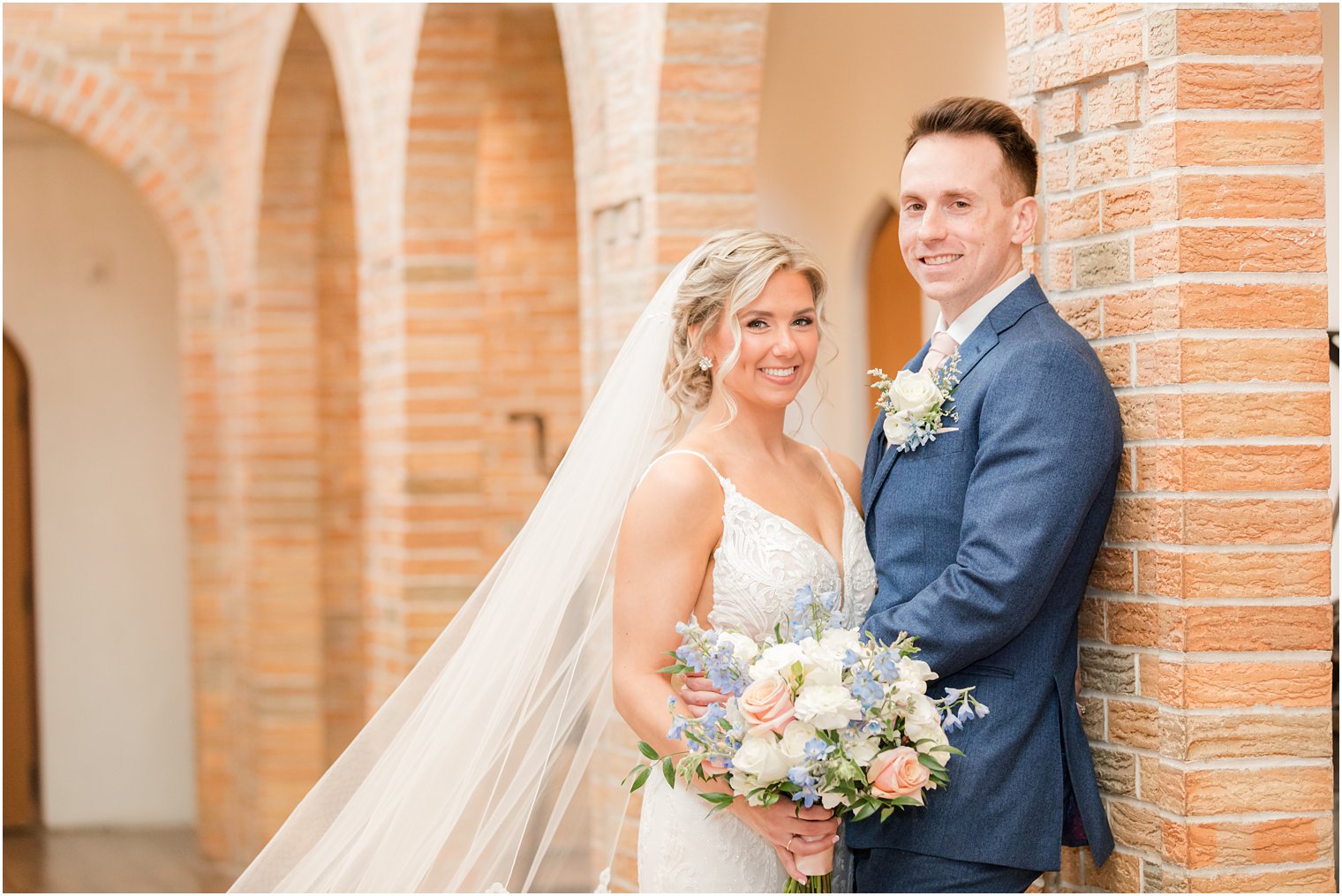 bride and groom smiling at camera at Renault Winery in Egg Harbor Township, NJ