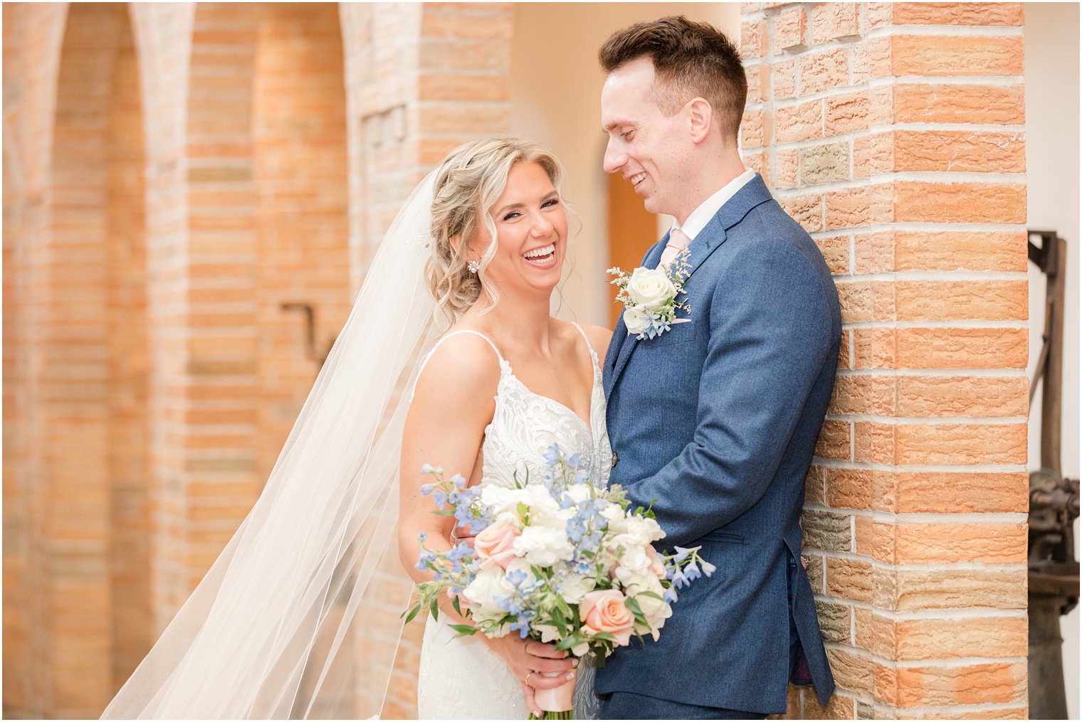 bride and groom laughing in photos at Renault Winery in Egg Harbor Township, NJ