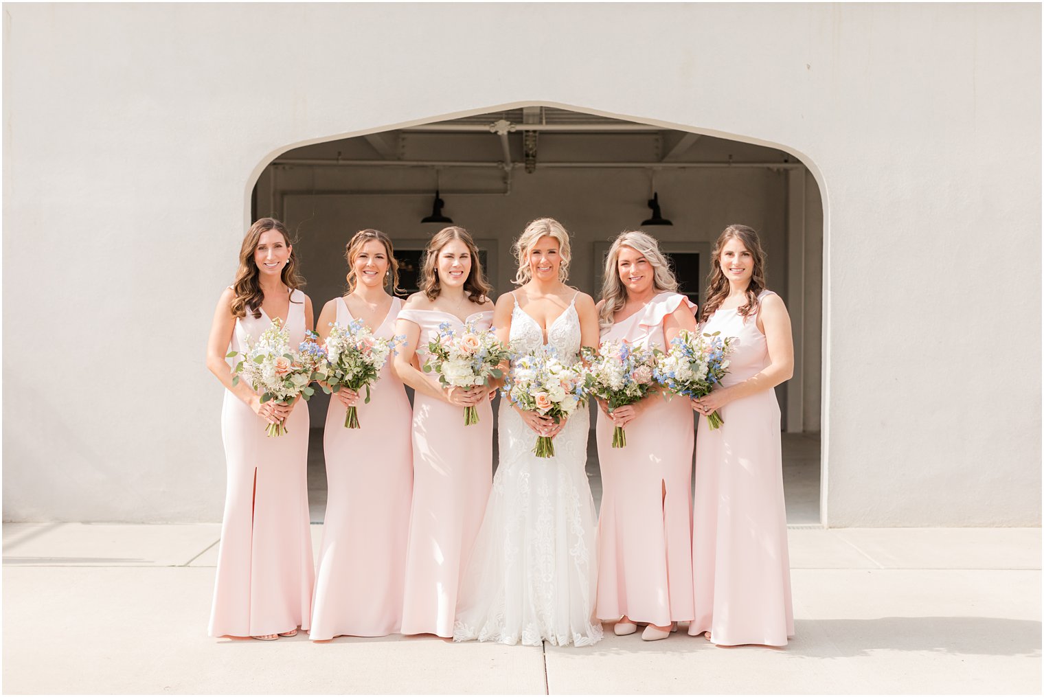 bride and bridesmaids in spring colors with florals by Betinas
