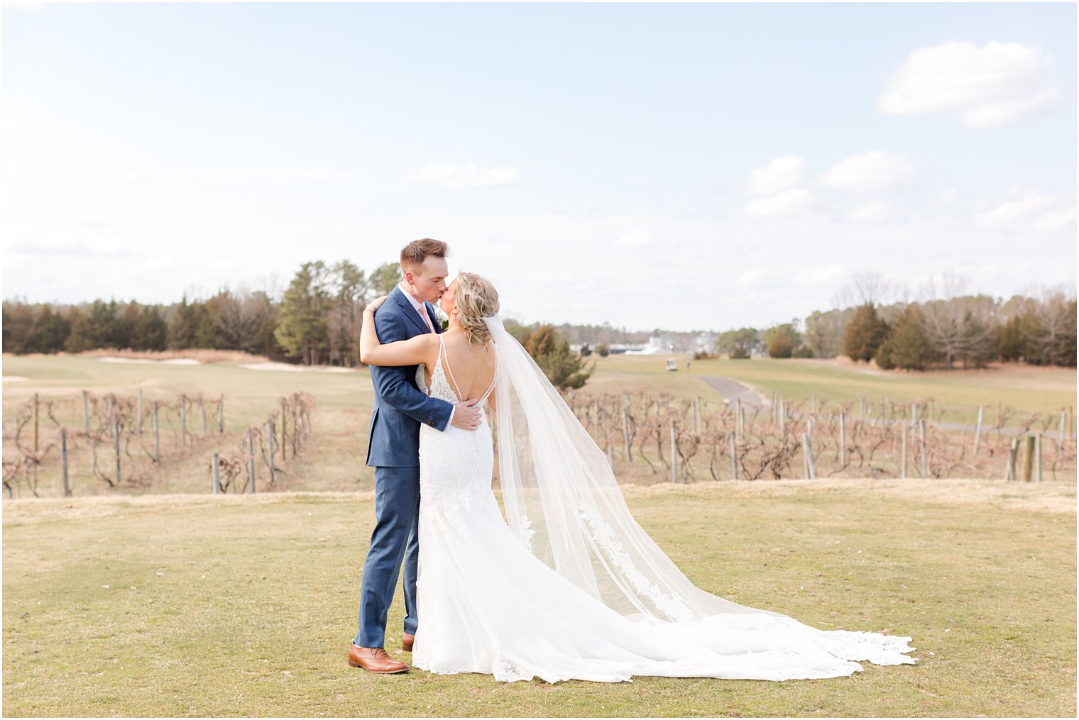 bride and groom kissing in vineyards at Renault Winery in Egg Harbor Township, NJ