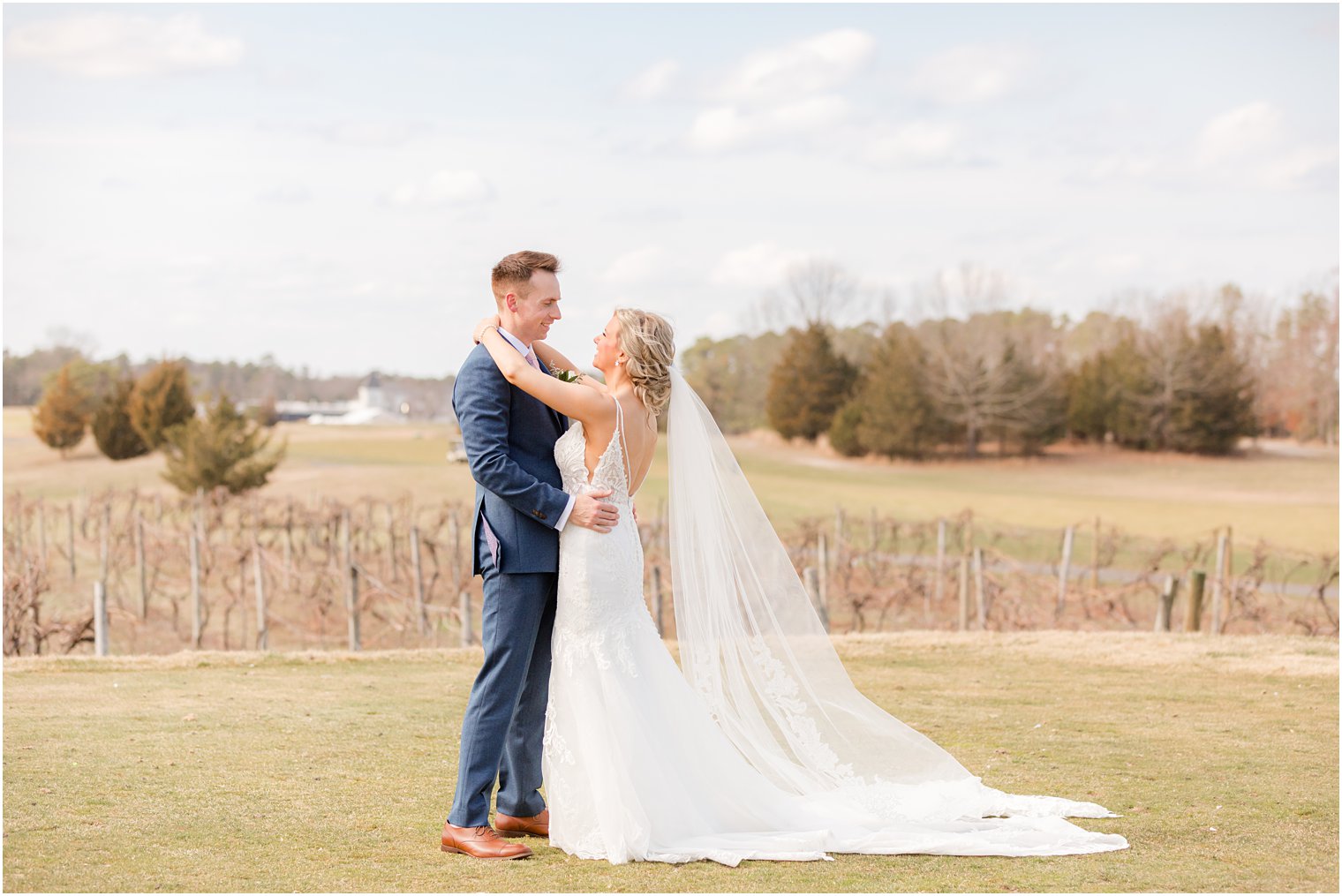 bride and groom smiling at each other at Renault Winery in Egg Harbor Township, NJ