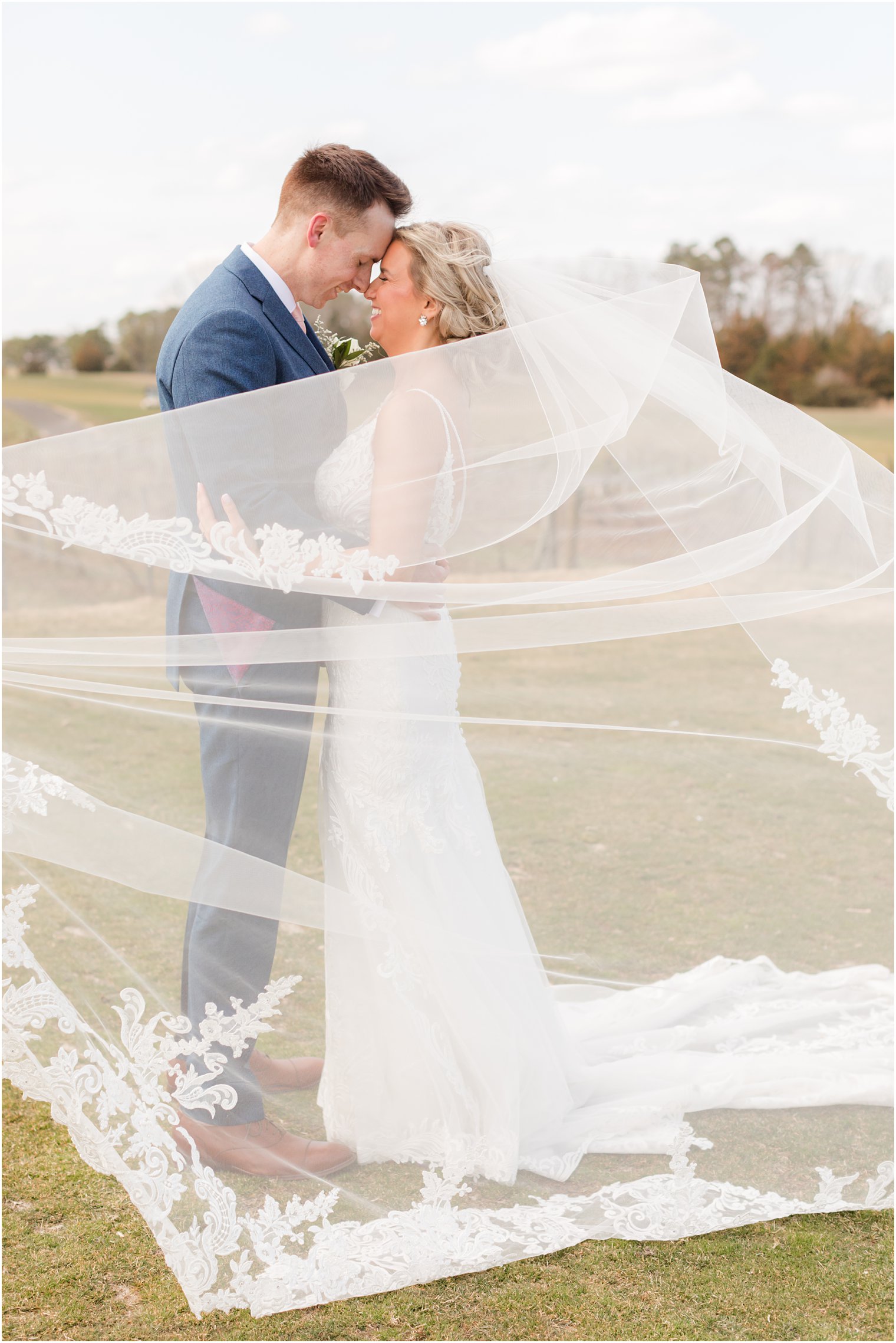 bride and groom photo with wind blowing cathedral veil | Renault Winery in Egg Harbor Township, NJ