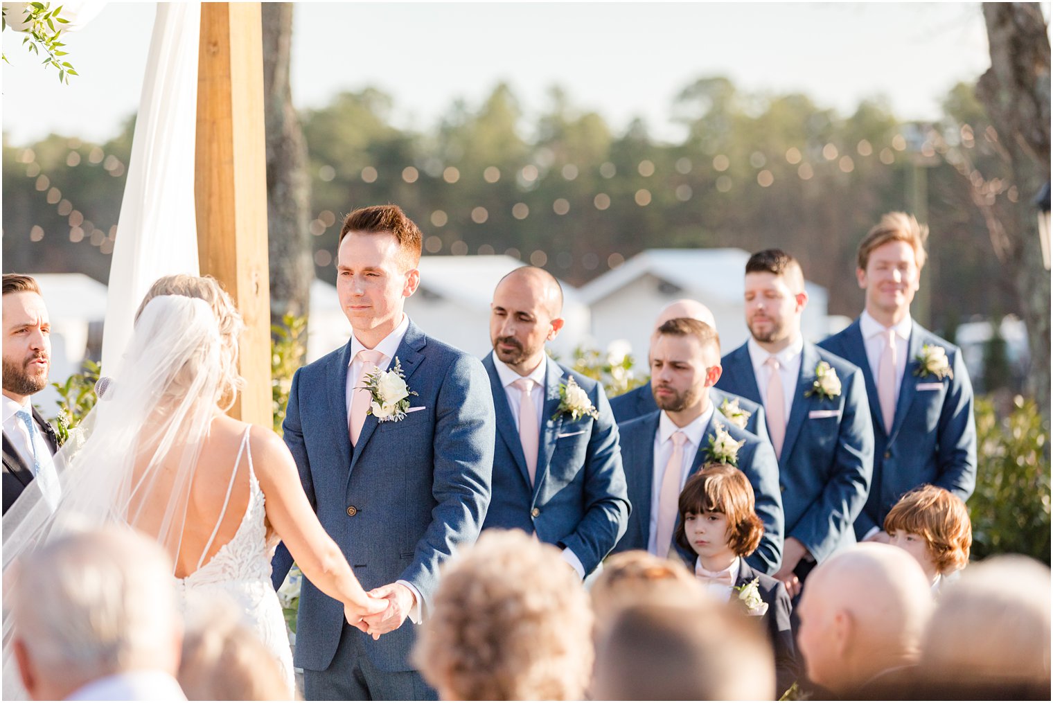 groom and groomsmen during outdoor ceremony at Renault Winery in Egg Harbor Township, NJ