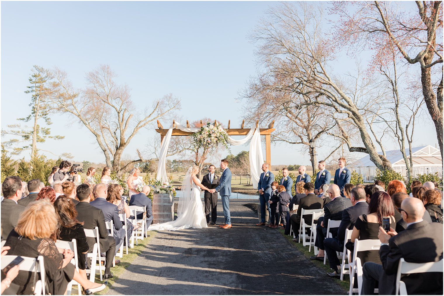 exchange of vows during outdoor ceremony at Renault Winery in Egg Harbor Township, NJ