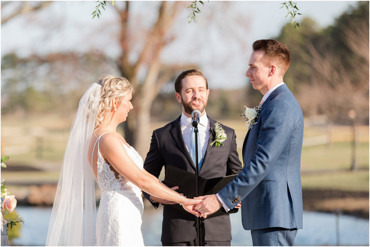 bride and groom getting married during outdoor ceremony at Renault Winery in Egg Harbor Township, NJ