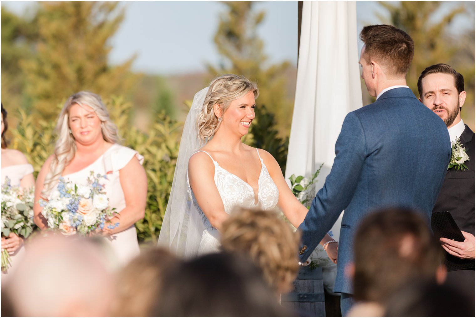 bride smiling during outdoor ceremony at Renault Winery in Egg Harbor Township, NJ